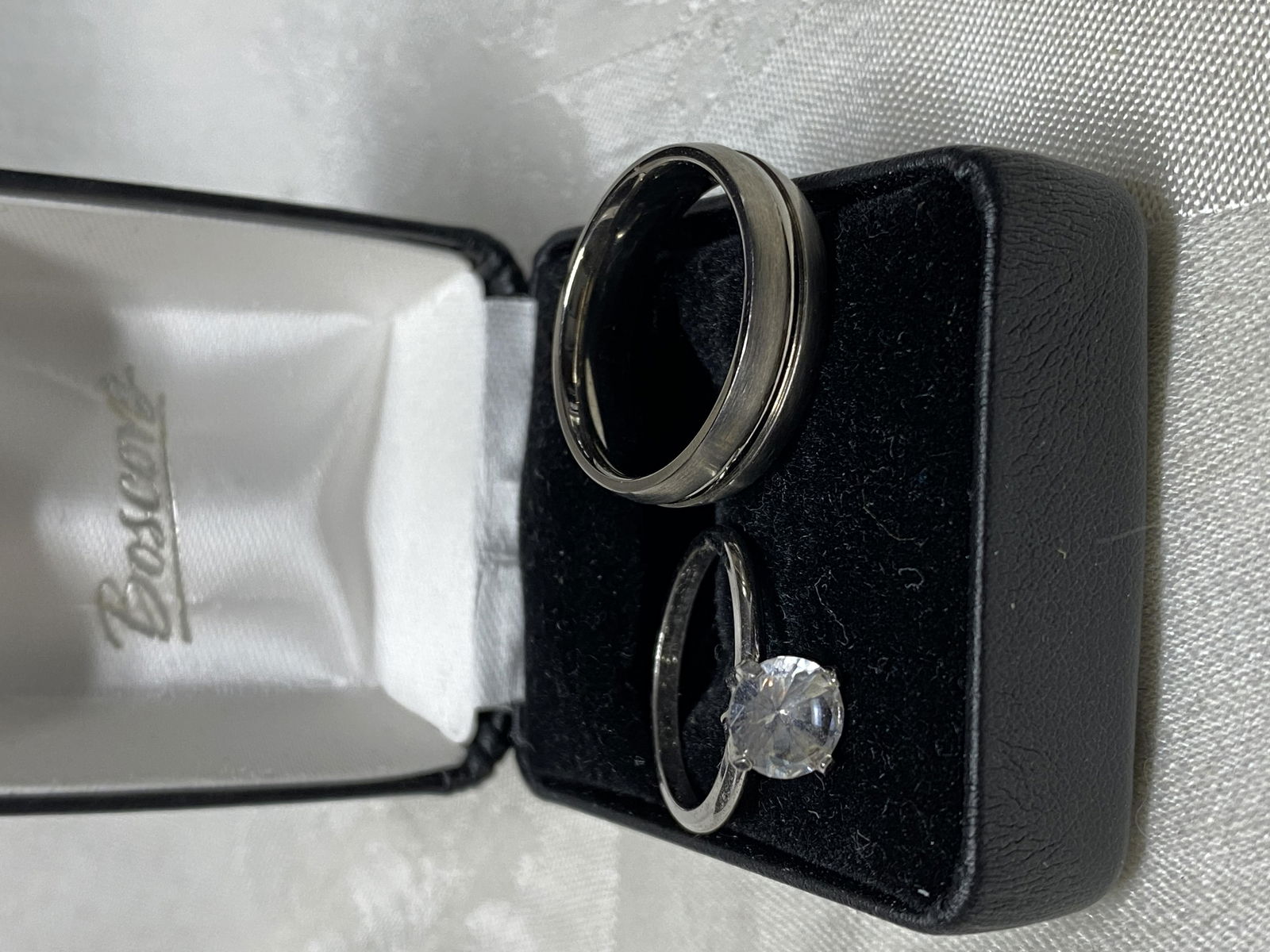 LOT OF (2) SILVER & TITANIUM BAND AND WEDDING RING: LOT OF (2) SILVER BAND AND WEDDING RING. A GREAT ADDITION TO YOUR COLLECTION.