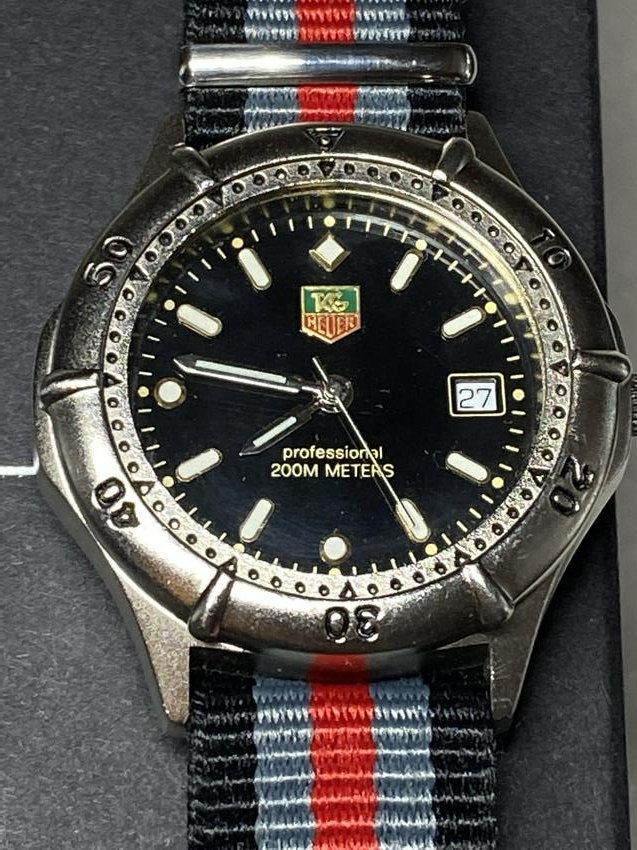 VINTAGE TAG HEUER 200M PROFESSIONAL WATCH W/NATO STRAP: VINTAGE TAG HEUER 200M PROFESSIONAL WATCH W/NATO STRAP. A GREAT ADDITION TO YOUR COLLECTION. SOLD AS-IS. WATCH KEEPS TIME. PLEASE VIEW PICTURES. COMES WITH THE BOX AS WELL.