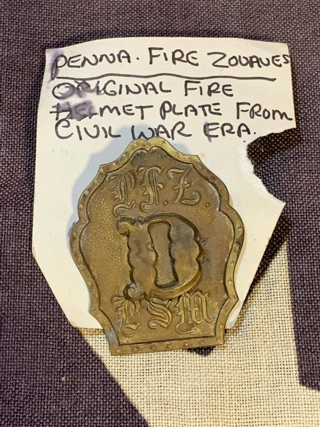 CIVIL WAR PA FIRE ZOUAVES FIRE HELMET PLATE: CIVIL WAR PA FIRE ZOUAVES FIRE HELMET PLATE. IN GOOD OVERALL SHAPE AND CONDITION WITH A BEAUTIFUL OVERALL PATINA. A GREAT FIND AND AN EXCELLENT ADDITION TO YOUR COLLECTION.