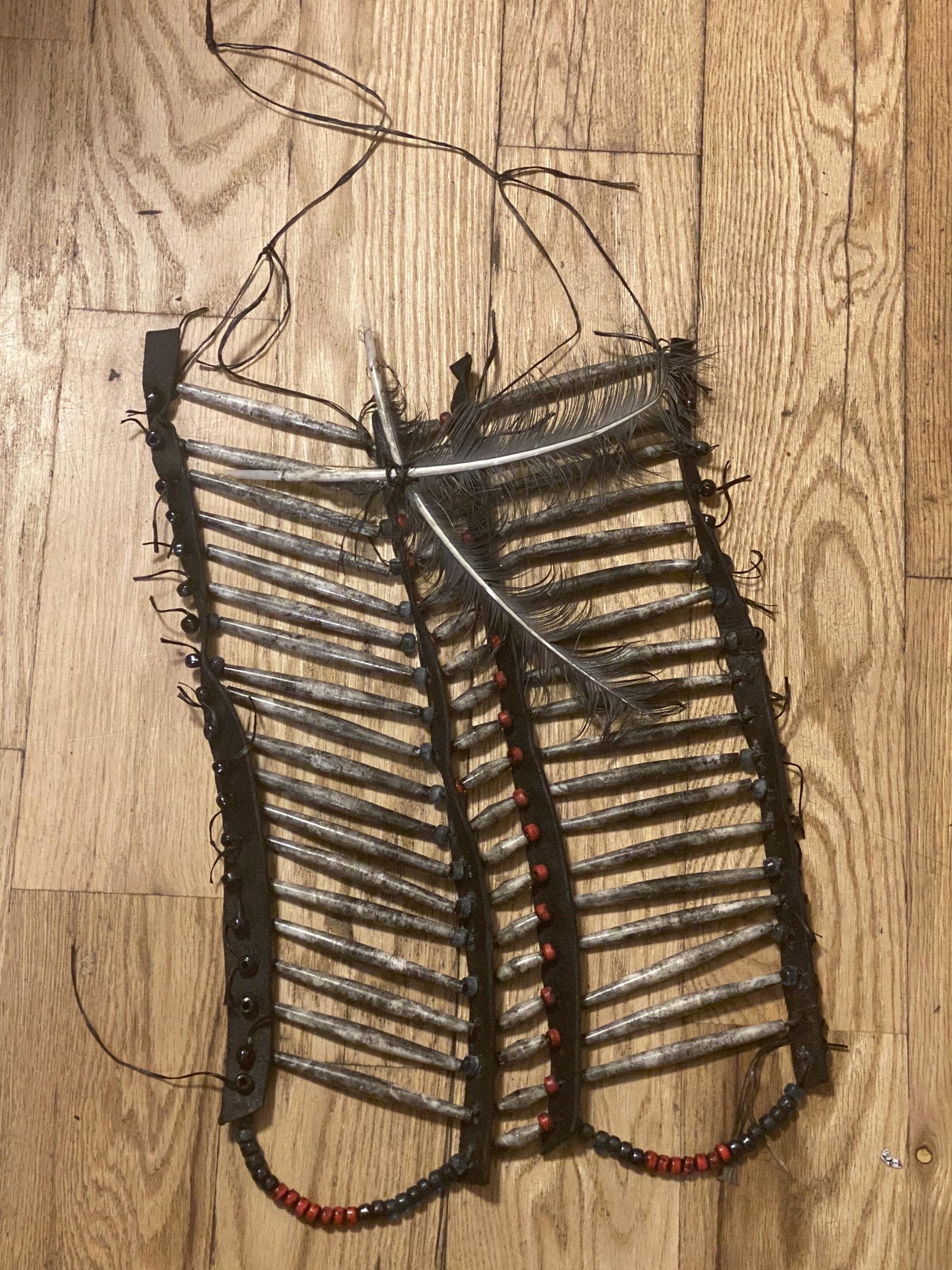 1800'S NATIVE AMERICAN CHILDS BREAST PLATE: 1800'S NATIVE AMERICAN CHILDS BREAST PLATE. ALL HAND-MADE AND IN MINT OVERALL SHAPE AND CONDITION. HAS A GREAT LOOK TO IT WITH AN EXCELLENT OVERALL EYE APPEL. BEAUTIFUL FEATHERS INLAID - PLEASE VIEW P