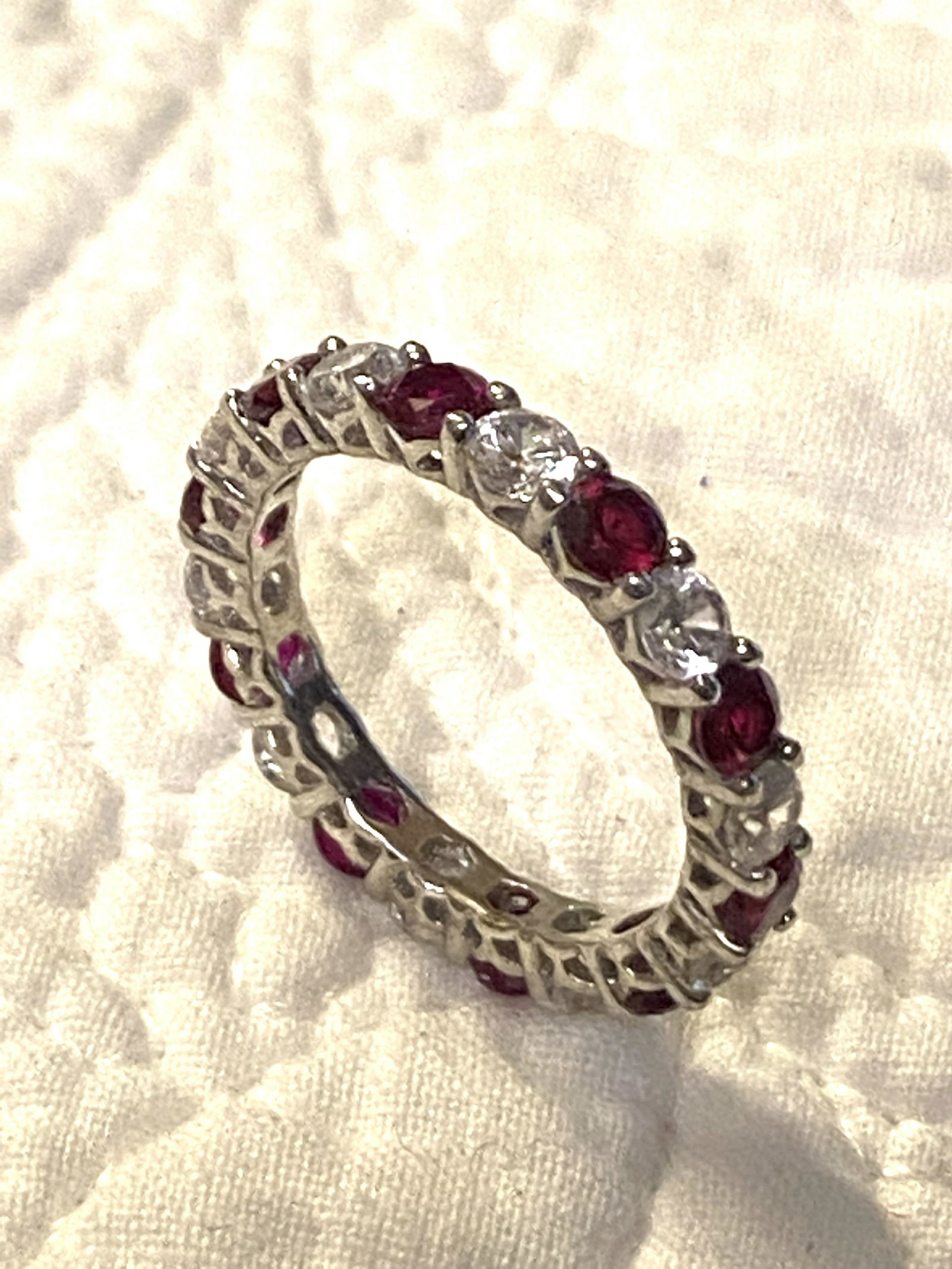 STERLING SILVER LADIES RUBY/CRYSTAL ETERNITY BAND: STERLING SILVER LADIES RUBY/CRYSTAL ETERNITY BAND. BAND IS A SIZE 7.5. A GREAT FIND AND AN EXCELLENT ADDITION TO YOUR COLLECTION.