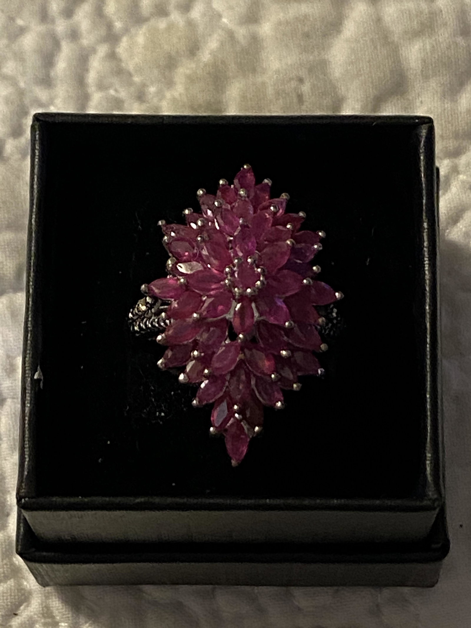 STERLING SILVER RUBY COCKTAIL FLORAL RING: STERLING SILVER RUBY COCKTAIL FLORAL RING. IN GOOD OVERALL SHAPE AND CONDITION. PLEASE VIEW ALL DETAILED PICTURES. A GREAT FIND AND AN EXCELLENT ADDITION TO YOUR COLLECTION. RING IS A SIZE 8.5.