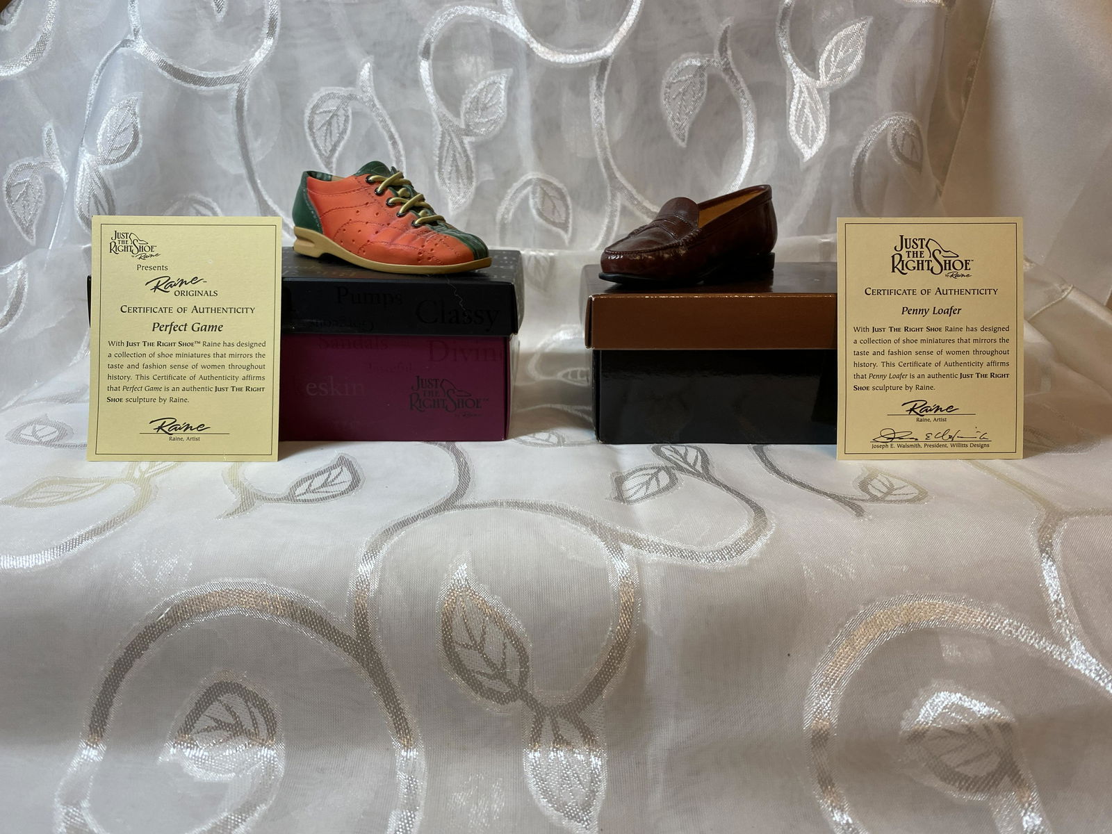 LOT OF (2) MINIATURE THE RIGHT SHOE COLLECTIBLE: LOT OF (2) MINIATURE THE RIGHT SHOE COLLECTIBLE. WITH JUST THE RIGHT SHOE RAINE HAS DESIGNED A COLLECTION OF SHOE MINIATURES THAT MIRRORS THE TASTE AND FASHION SENSE OF WOMEN THROUGHOUT HISTORY. A GRE