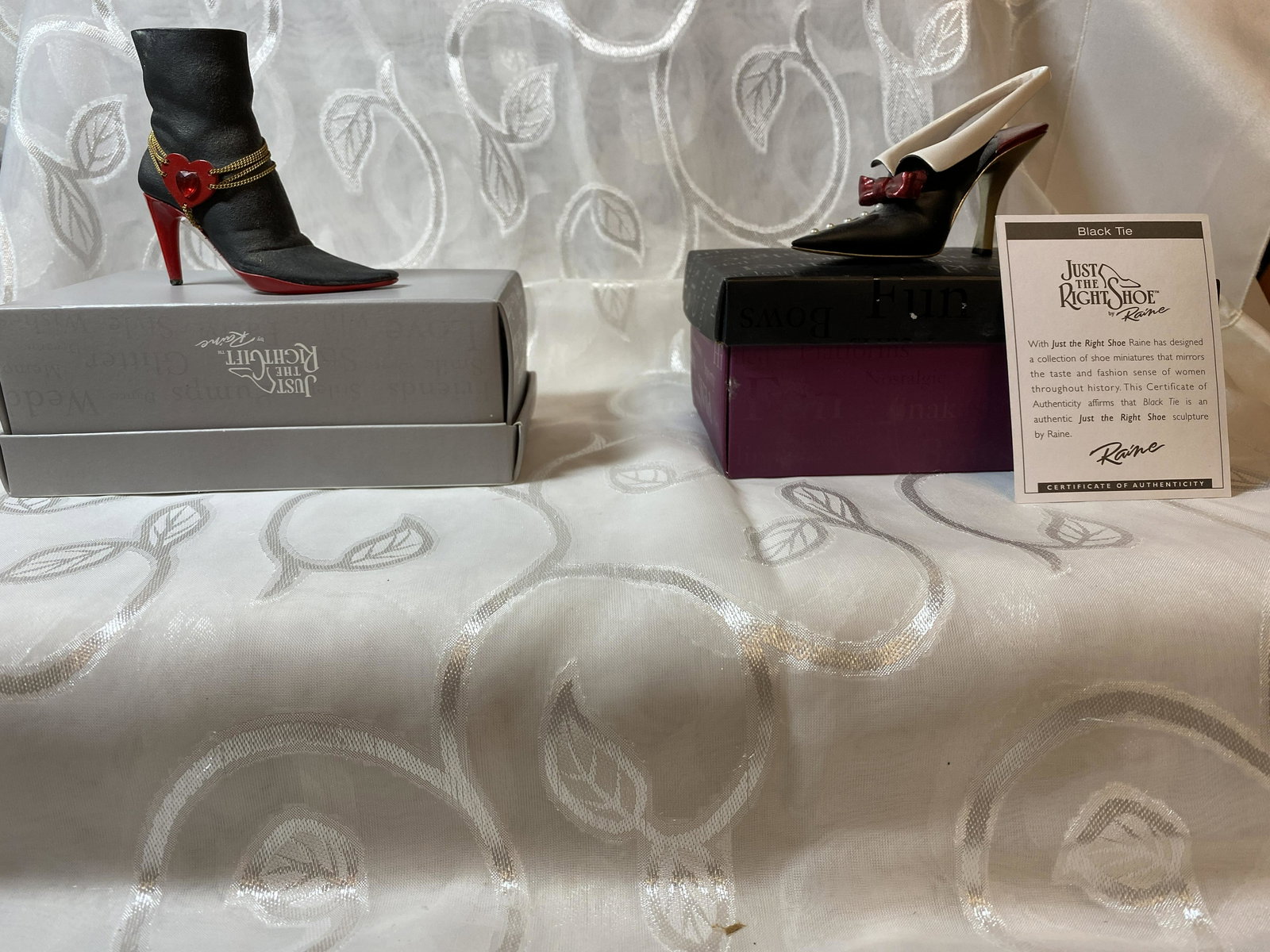 LOT OF (2) MINIATURE THE RIGHT SHOE COLLECTIBLE: LOT OF (2) MINIATURE THE RIGHT SHOE COLLECTIBLE. WITH JUST THE RIGHT SHOE RAINE HAS DESIGNED A COLLECTION OF SHOE MINIATURES THAT MIRRORS THE TASTE AND FASHION SENSE OF WOMEN THROUGHOUT HISTORY. A GRE