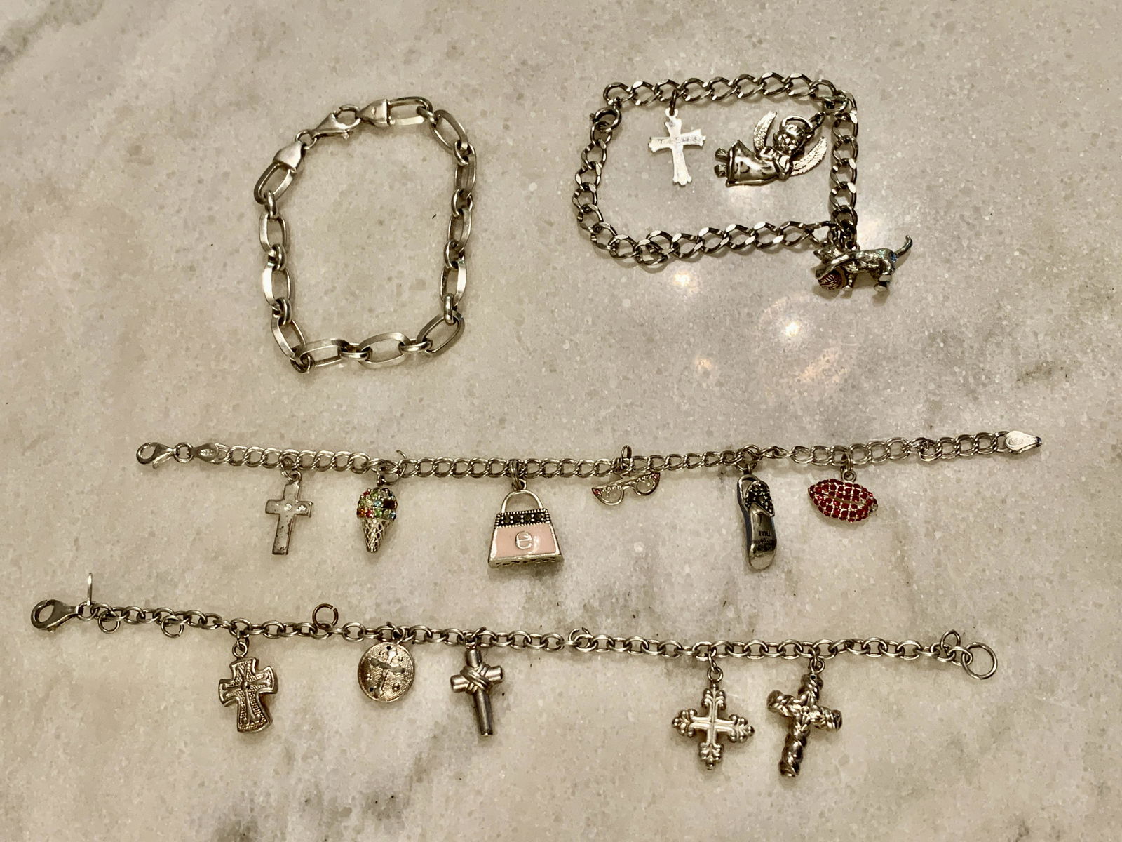LOT OF (4) STERLING SILVER CHARM BRACELETS: LOT OF (4) STERLING SILVER CHARM BRACELETS. IN GOOD OVERALL SHAPE AND CONDITION. A GREAT FIND AND AN EXCELLENT ADDITION TO YOUR COLLECTION.