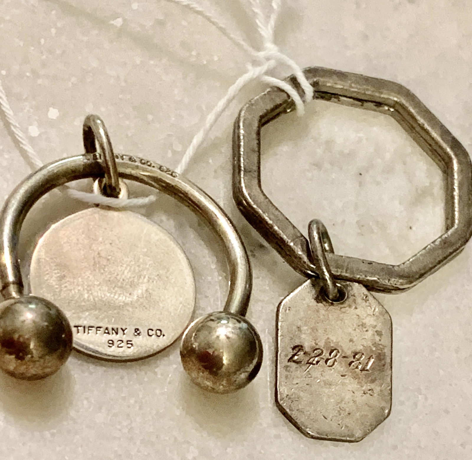 LOT OF (2) STERLING SILVER KEYCHAINS - TIFFANY & CO.: LOT OF (2) STERLING SILVER KEYCHAINS - INCLUDES TIFFANY & CO KEYCHAIN. IN GOOD OVERALL SHAPE AND CONDITION. PLEASE VIEW ALL DETAILED PICTURES. A GREAT FIND AND AN EXCELLENT ADDITION TO YOUR COLLECTION