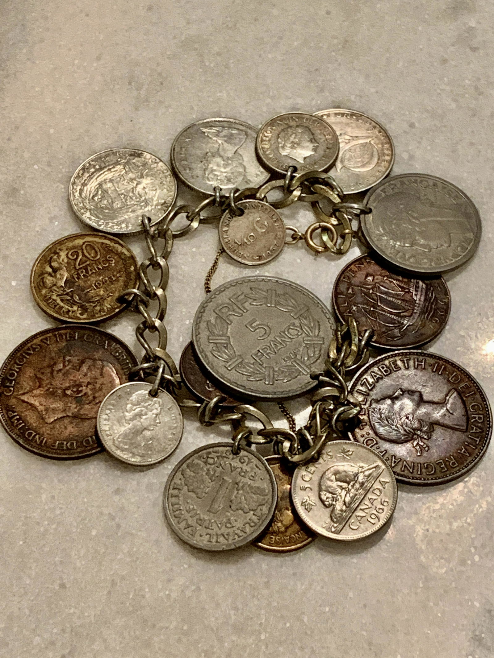 ANTIQUE FOREIGN COINS CHARM BRACELET: ANTIQUE FOREIGN COINS CHARM BRACELET. IN GOOD OVERALL SHAPE AND CONDITION. A GREAT FIND AND AN EXCELLENT ADDITION TO YOUR COLLECTION.