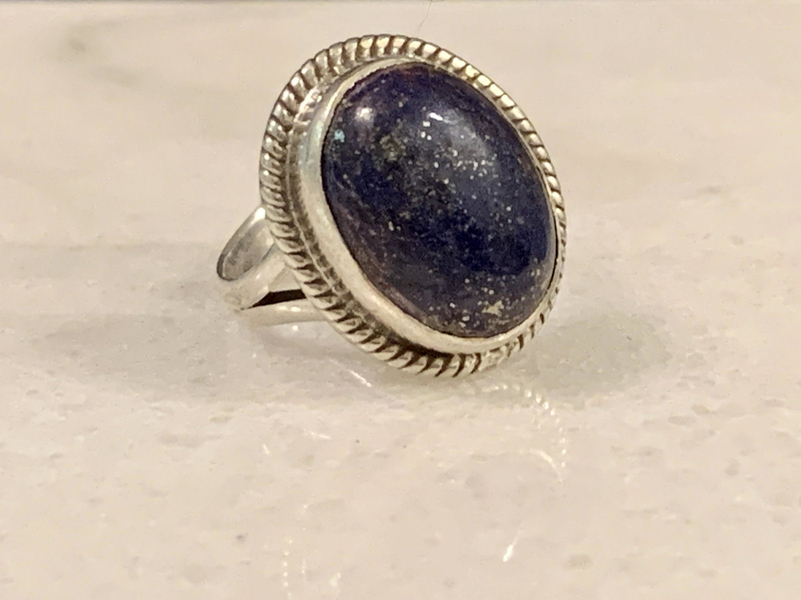 RETRO STERLING SILVER 4 CT LAPIS LAZULI COCKTAIL RING: RETRO STERLING SILVER 4 CT LAPIS LAZULI COCKTAIL RING. RING IS A SIZE 6. IN GOOD OVERALL SHAPE AND CONDITION. A GREAT FIND AND AN EXCELLENT ADDITION TO YOUR COLLECTION.