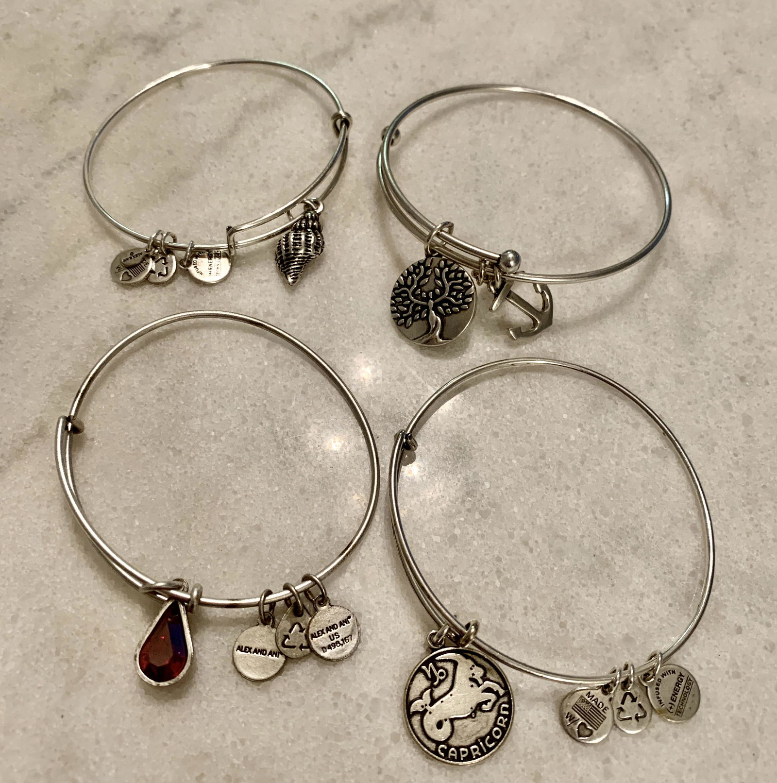 COLLECTIBLE LOT OF (4) LADIES SILVER CHARM BRACELETS: COLLECTIBLE LOT OF (4) LADIES SILVER CHARM BRACELETS. A GREAT FIND AND AN EXCELLENT ADDITION TO YOUR COLLECTION.