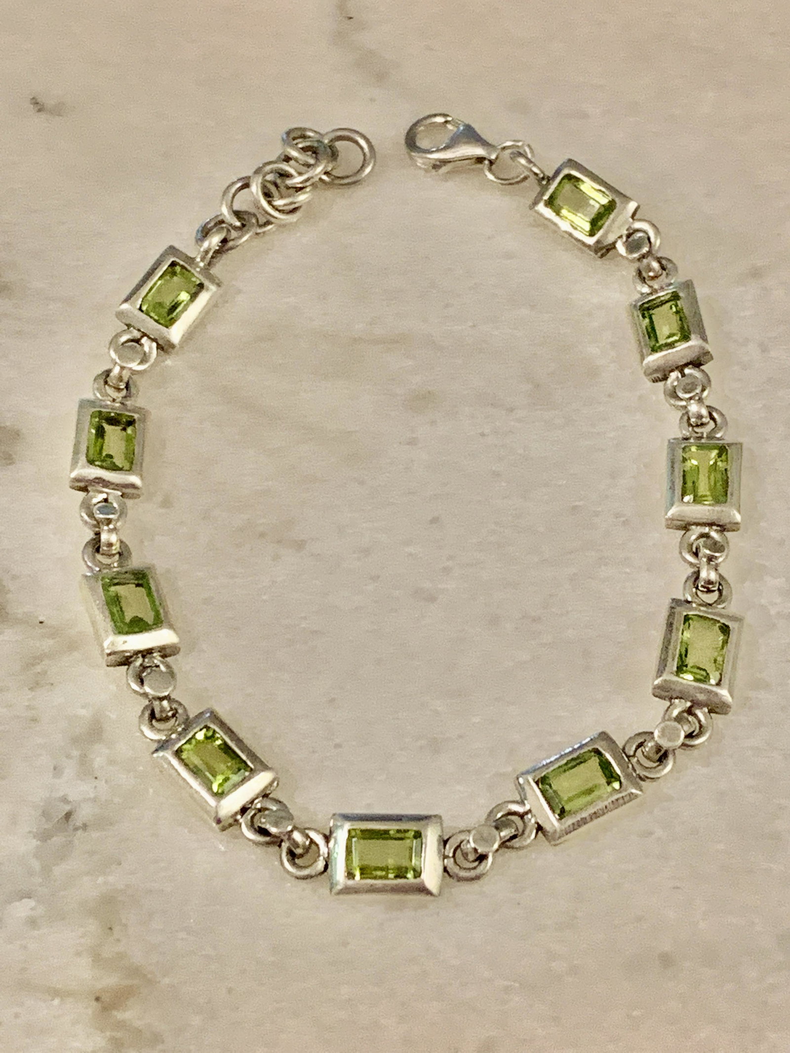 STERLING SILVER LADIES PERIDOT TENNIS BRACELET: STERLING SILVER LADIES PERIDOT TENNIS BRACELET. IN GOOD OVERALL SHAPE AND CONDITION. A GREAT FIND AND AN EXCELLENT ADDITION TO YOUR COLLECTION.