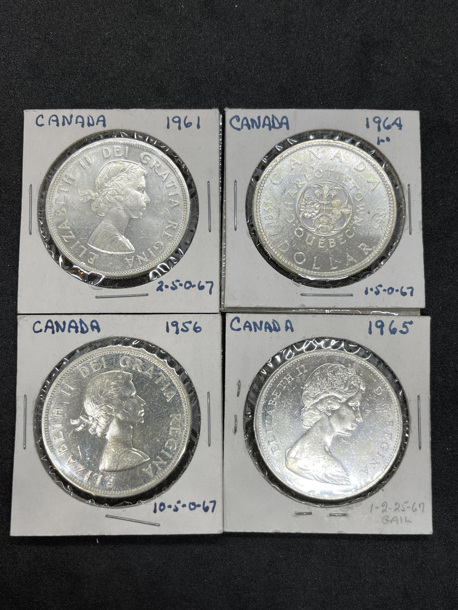 COLLECTION LOT OF (4) CANADIAN SILVER DOLLARS: COLLECTION LOT OF (4) CANADIAN SILVER DOLLARS. SOLD AS A LOT - ALL FOR ONE MONEY!