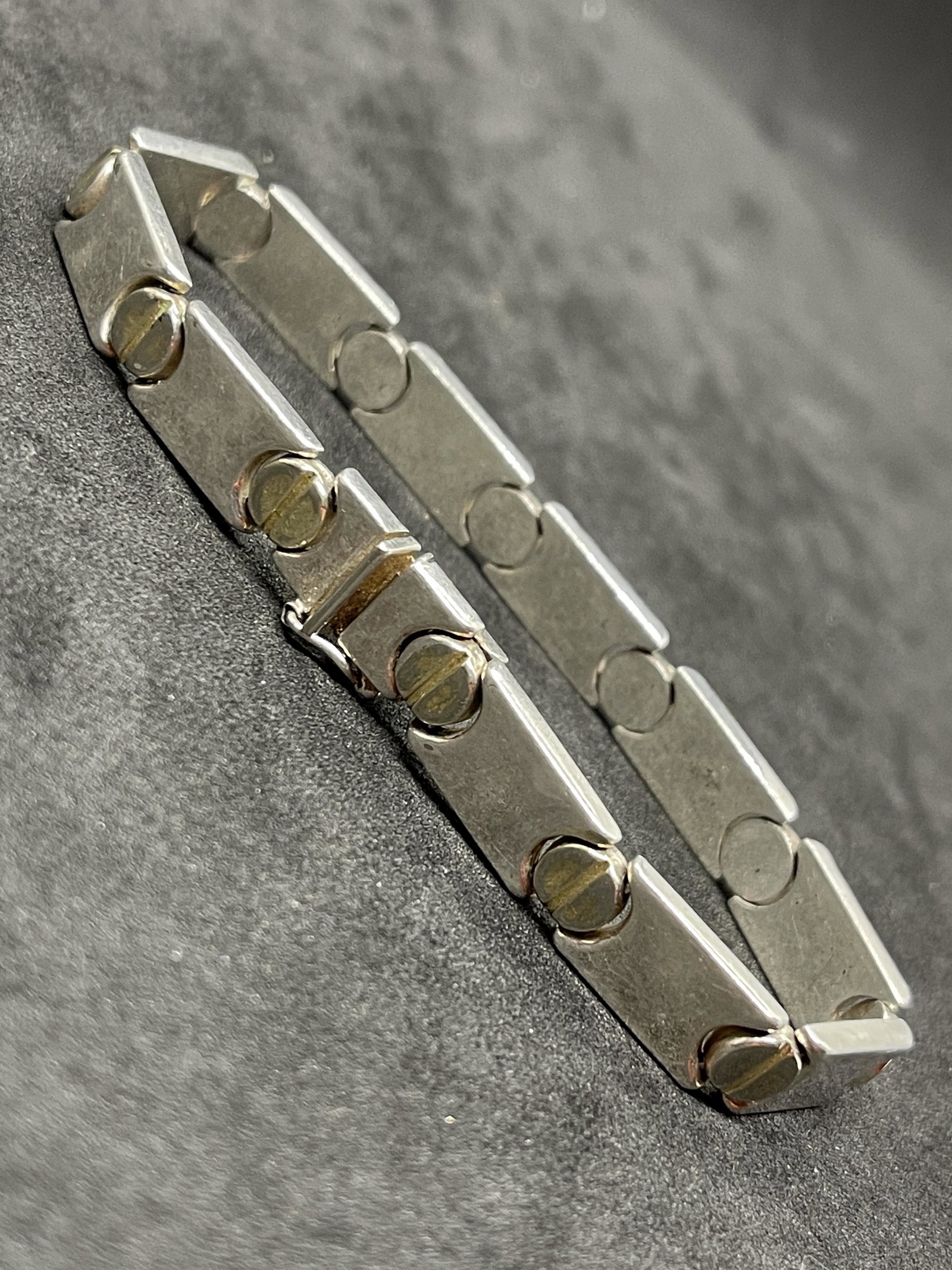 HOMAGE TO CARTIER STERLING SILVER BRACELET: HOMAGE TO CARTIER STERLING SILVER BRACELET. THIS IS A VINTAGE BRACELET MADE TO LOOK LIKE THE DISCONTINUED CARTIER BRACELET. HAS A GREAT LOOK TO IT WITH AN EXCELLENT OVERALL EYE APPEAL. A GREAT FIND AN