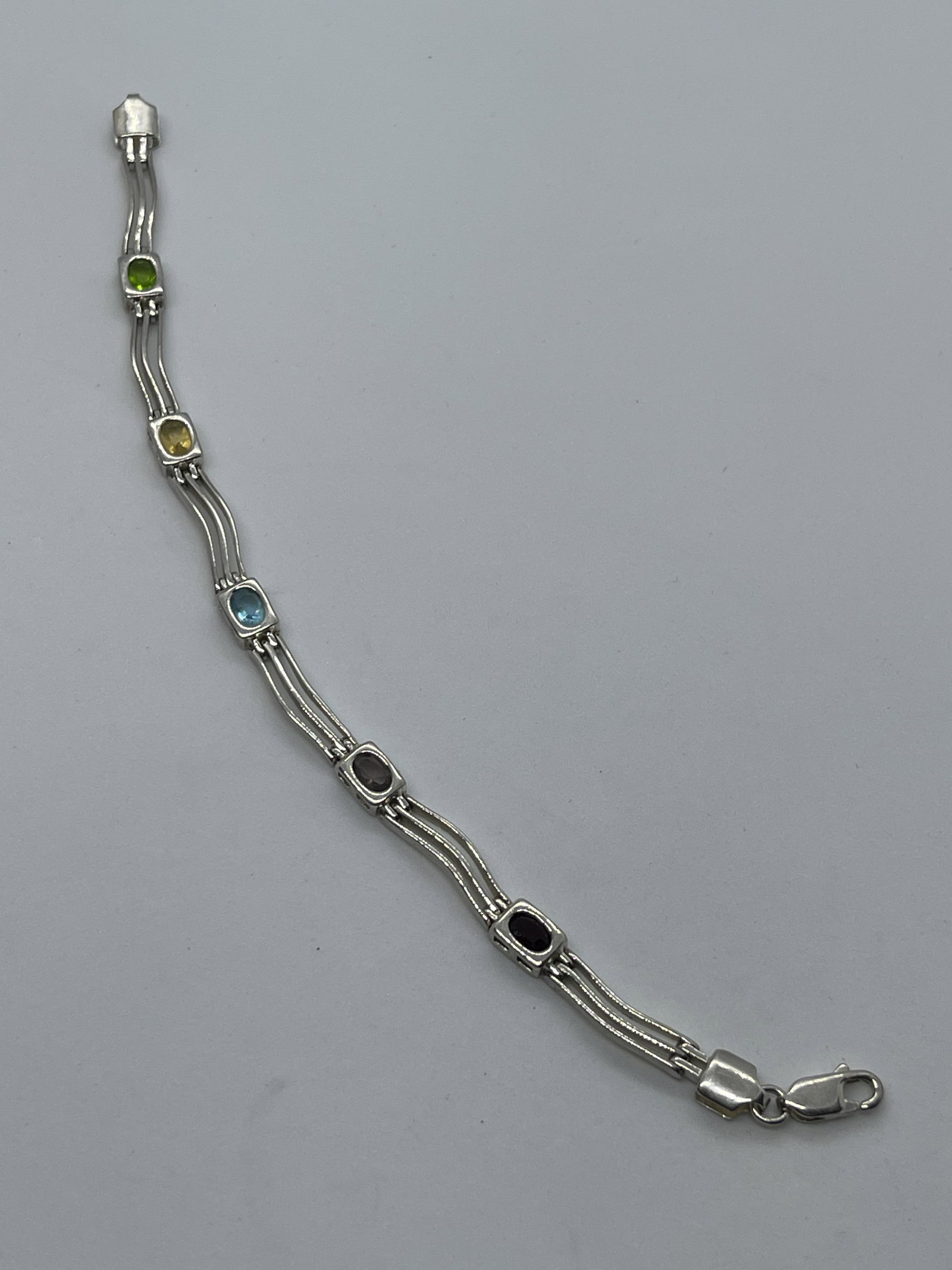 RETRO STERLING 1.25 TCW MULTI-GEMSTONE WAVE BRACELET: RETRO STERLING 1.25 TCW MULTI-GEMSTONE WAVE BRACELET. IN MINT OVERALL SHAPE AND CONDITION. HAS A GREAT LOOK TO IT WITH AN EXCELLENT OVERALL EYE APPEAL. A GREAT FIND AND AN EXCELLENT ADDITION TO YOUR C