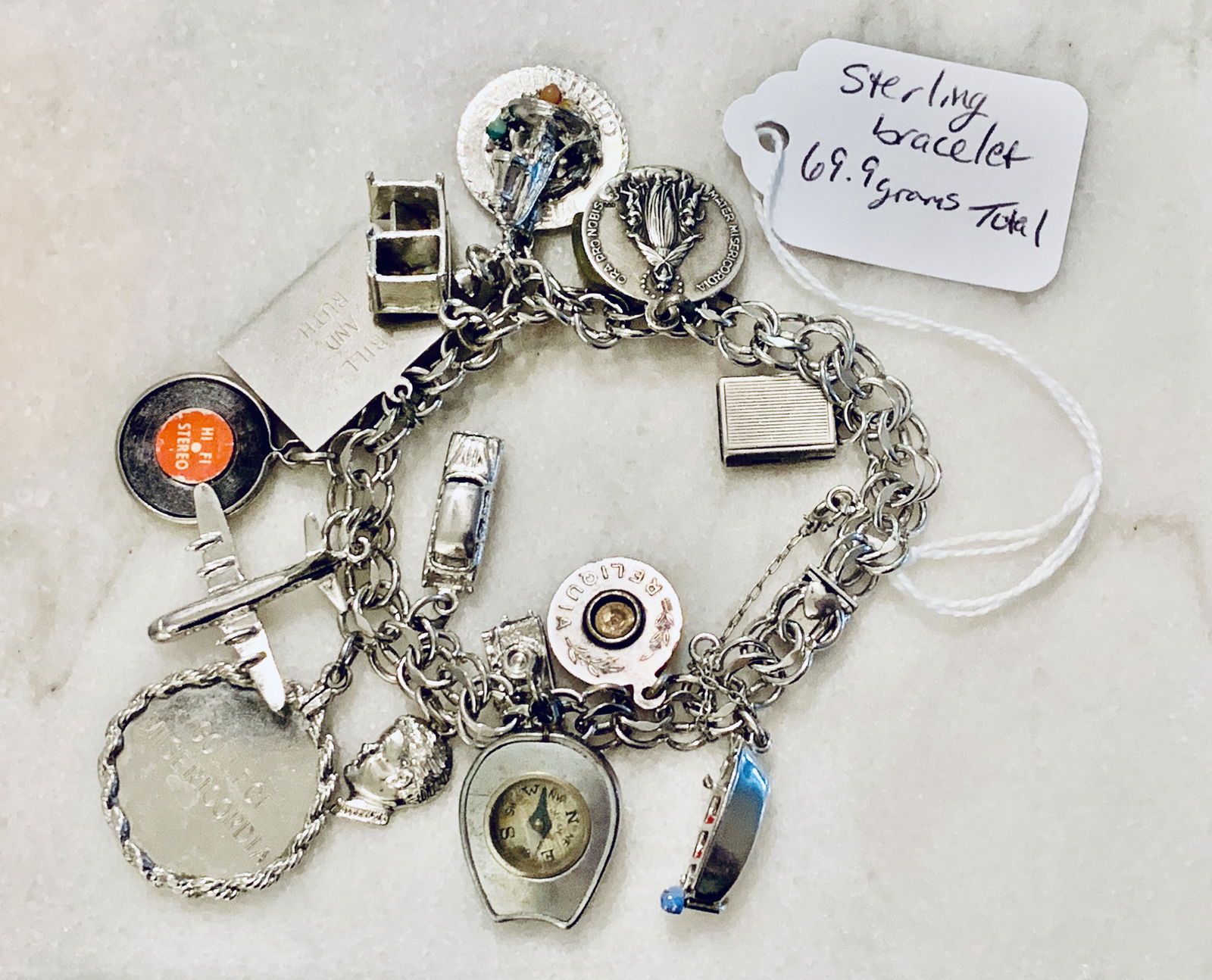 RETIRED CHARMS STERLING SILVER BRACELET 69.9 GRAMS: RETIRED CHARMS STERLING SILVER BRACELET 69.9 GRAMS. IN MINT OVERALL SHAPE AND CONDITION. CHARMS INCLUDE: COMPASS, PLANTE, ETC. PLEASE VIEW ALL DETAILED PICTURES. A GREAT FIND AND AN EXCELLENT ADDITION