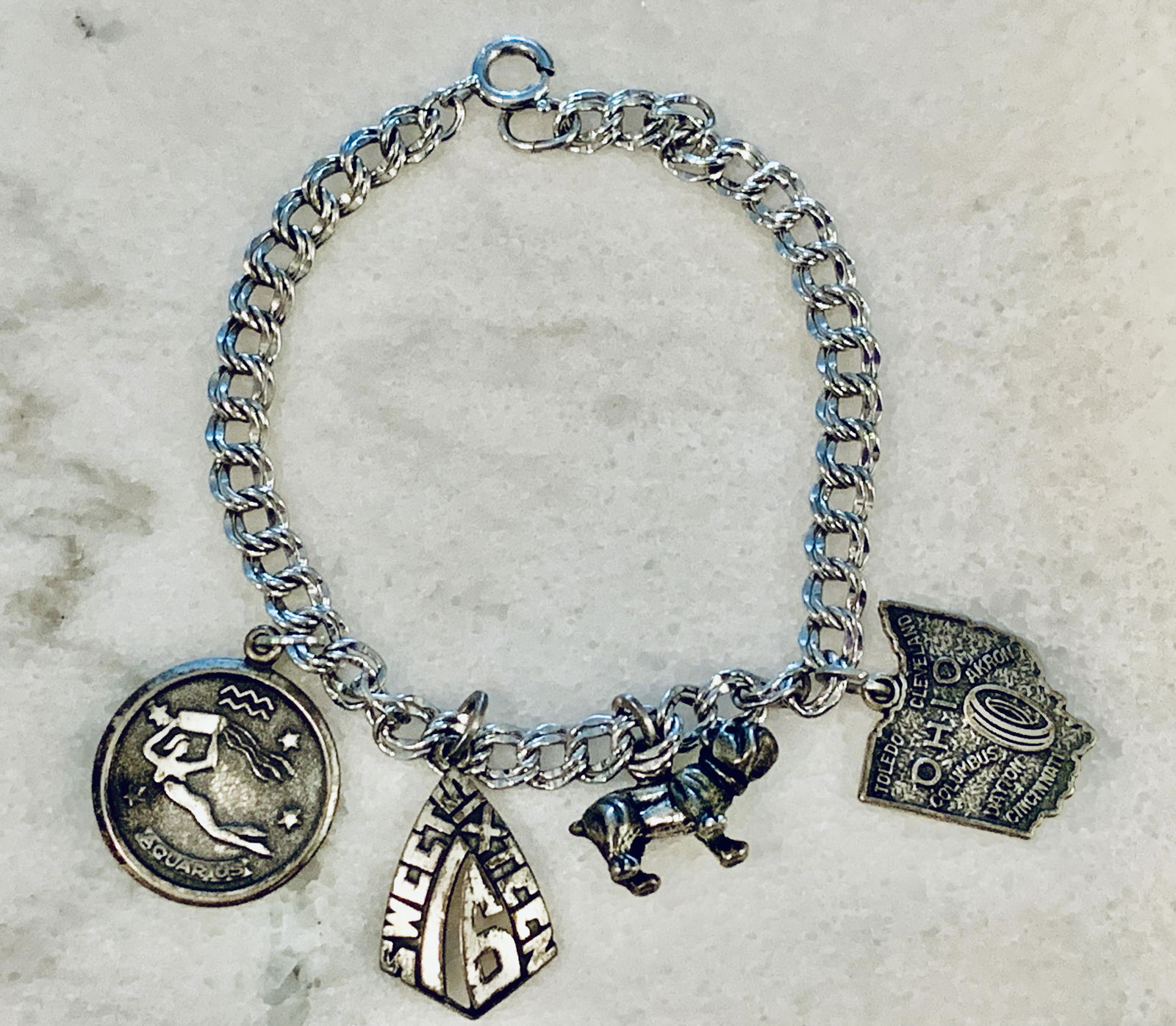 STERLING SILVER RETIRED CHARMS COCKTAIL BRACELET: STERLING SILVER RETIRED CHARMS COCKTAIL BRACELET. IN GOOD OVERALL SHAPE AND CONDITION. A GREAT FIND AND AN EXCELLENT ADDITION TO YOUR COLLECTION.