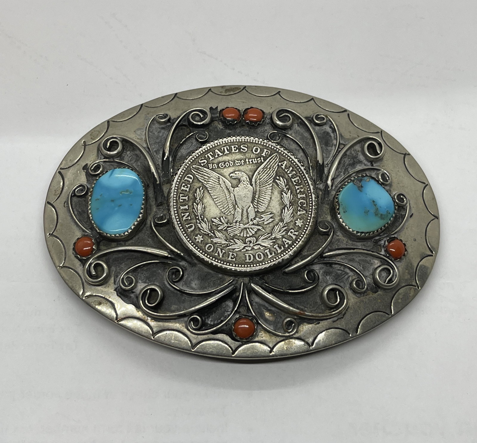 SQUAW WRAP NATIVE AMERICAN SILVER DOLLAR BELT BUCKLE: SQUAW WRAP NATIVE AMERICAN SILVER DOLLAR BELT BUCKLE. INLIAD WITH A MORGAN SILVER DOLLAR, TURQUOISE AND CORALS. PLEASE VIEW ALL DETAILED PICTURES. A GREAT FIND AND AN EXCELLENT ADDITION TO YOUR COLLEC