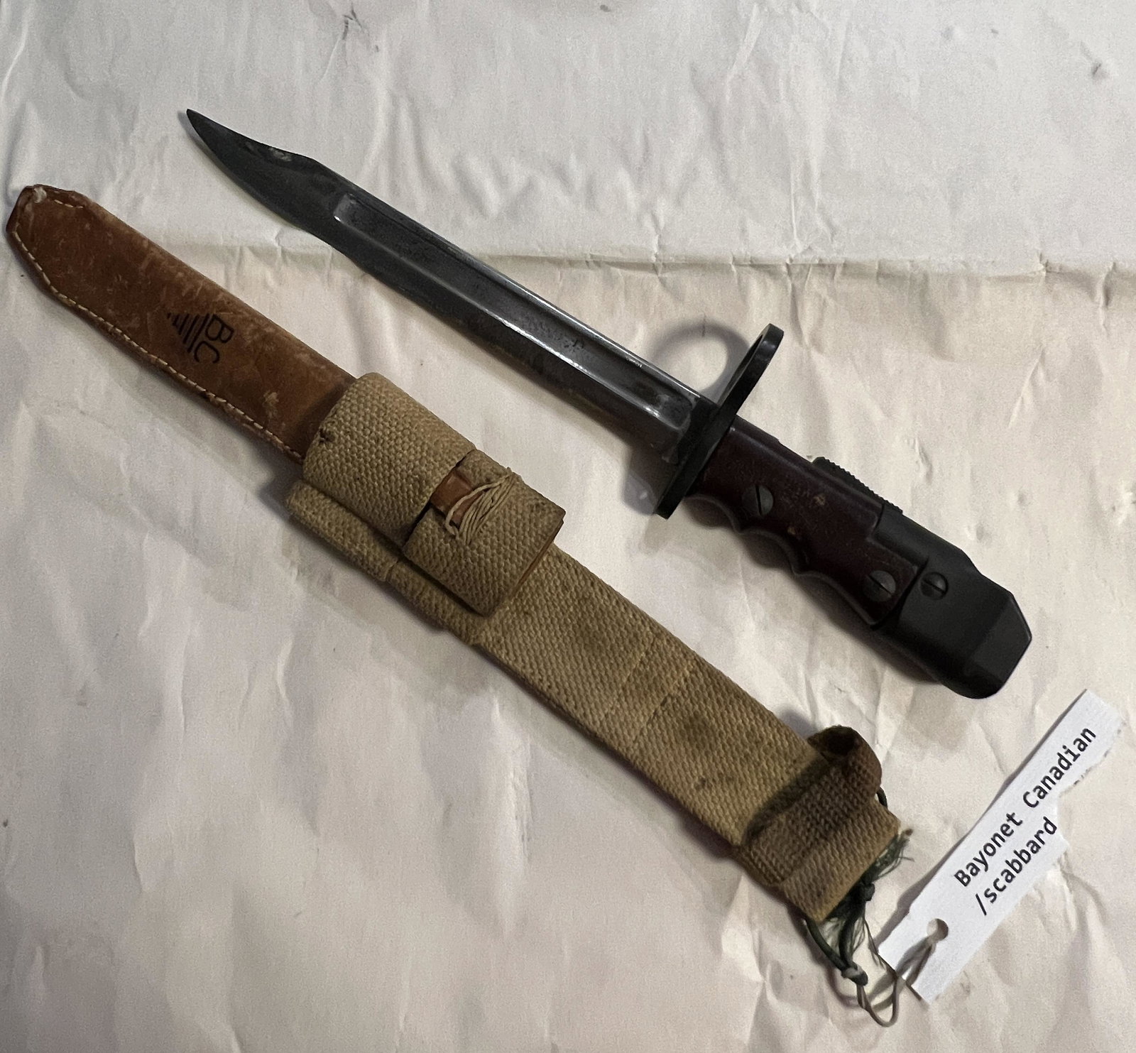 WW2 CANADIAN BAYONET WITH CANVAS SCABBARD: WW2 CANADIAN BAYONET WITH CANVAS SCABBARD. IN MINT OVERALL SHAPE AND CONDITION. HAS A GREAT LOOK TO IT WITH AN EXCELLENT OVERALL EYE APPEAL. PLEASE VIEW ALL DETAILED PICTURES. A GREAT FIND AND AN EXCE