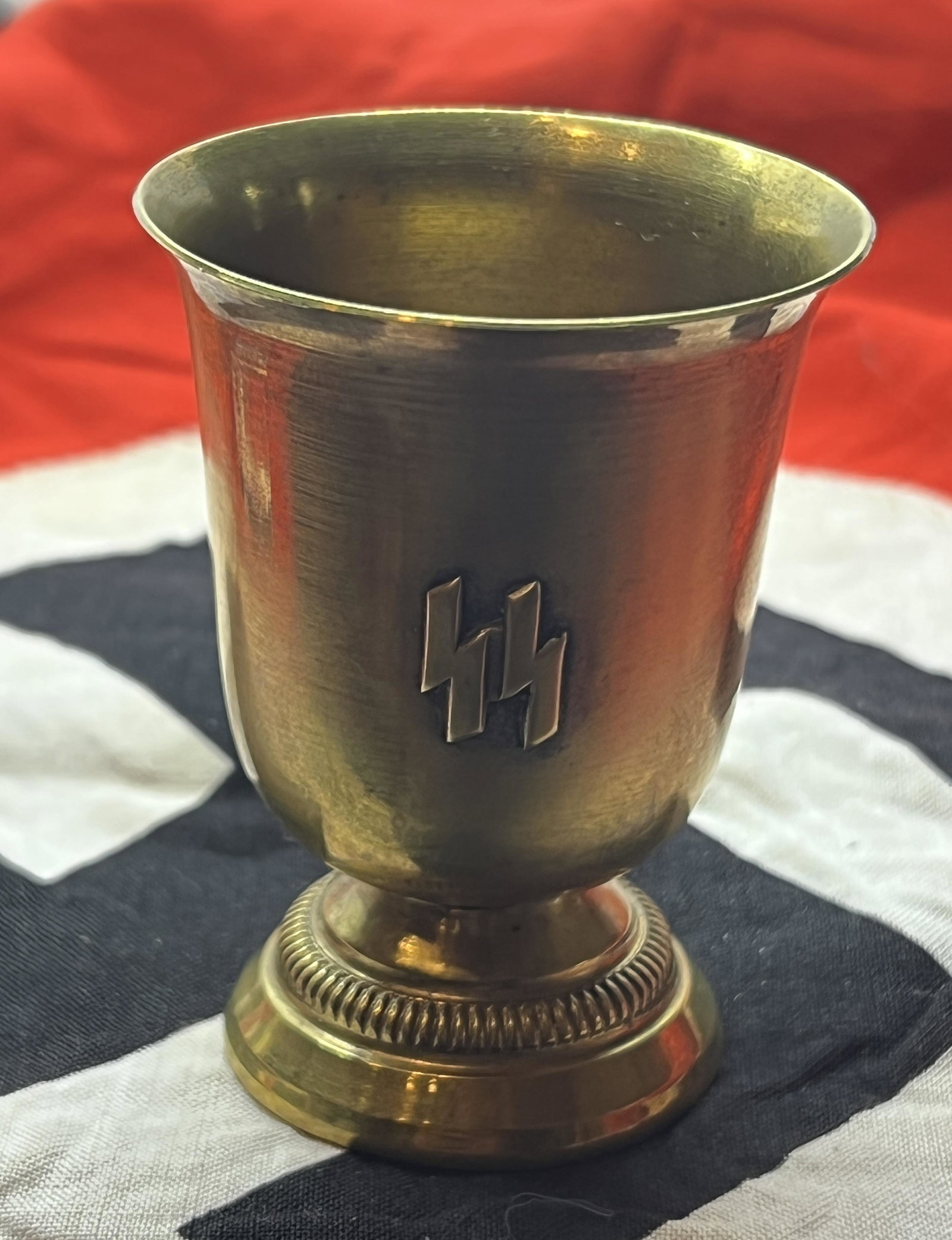 RARE WW2 GERMAN WAFFEN SS OFFICER SHOT GLASS: RARE WW2 GERMAN WAFFEN SS OFFICER SHOT GLASS. A VERY RARE GLASS MADE OUT OF BRASS. HAS THE SS MARKINGS ON THE FRONT. WAS BROUGHT BACK HOME BY A VET. PLEASE VIEW ALL DETAILED PICTURES. A GREAT FIND AND