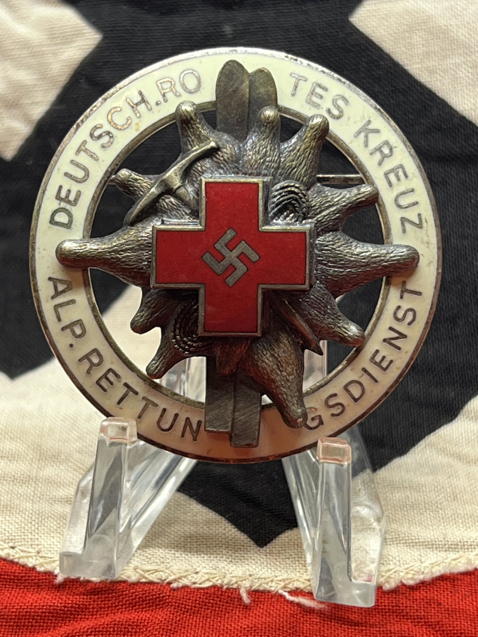 WW2 GERMAN ALPINE RED CROSS ENAMELED SKI BADGE: WW2 GERMAN ALPINE RED CROSS ENAMELED SKI BADGE. IN MINT OVERALL SHAPE AND CONDITION WITH A BEAUTIFUL OVERALL PATINA. HAS THE MAKER MARKS ON THE BACK. WAS BROUGHT BACK HOME BY A VET. A GREAT FIND AND A