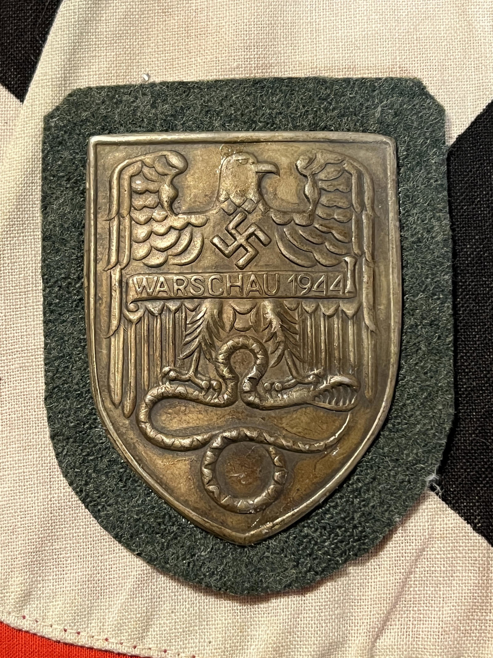 WW2 GERMAN WARSCHAU 1944 SHIELD SLEEVE BADGE: WW2 GERMAN WARSCHAU 1944 SHIELD SLEEVE BADGE. HAS THE MAKER MARKS ON THE BACK. IT IS IN MINT OVERALL SHAPE AND CONDITION. PLEASE VIEW ALL DETAILED PICTURES. A GREAT FIND AND AN EXCELLENT ADDITION TO Y