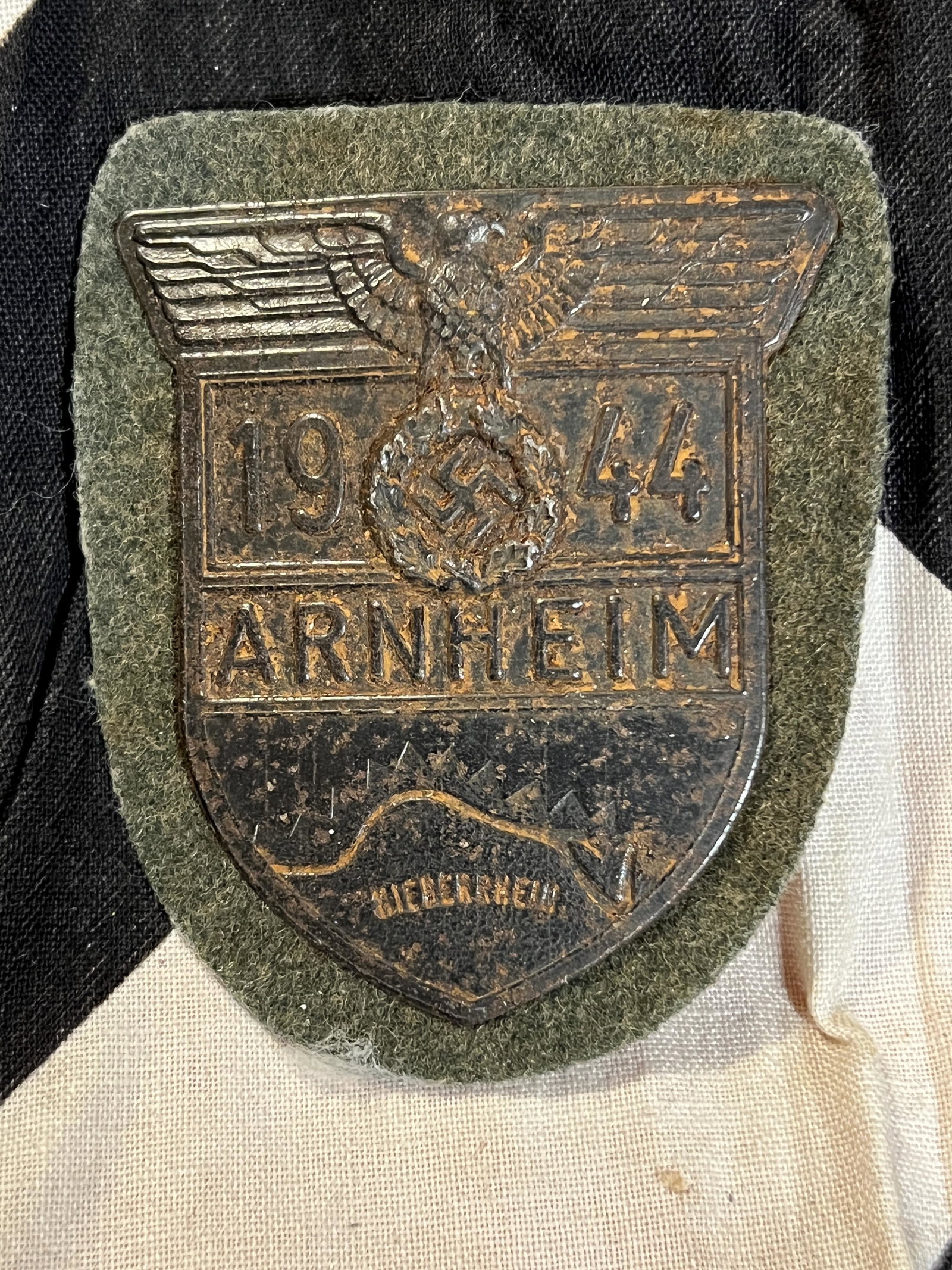 DATED 1944 WW2 GERMAN ARNHEIM SHIELD SLEEVE BADGE: DATED 1944 WW2 GERMAN ARNHEIM SHIELD SLEEVE BADGE. A RARE FIND. SHOWS HEAVY USE AND WEAR. PLEASE VIEW ALL DETAILED PICTURES. WOULD MAKE AN EXCEPTIONAL ADDITION TO YOUR COLLECTION. A RARE FIND.