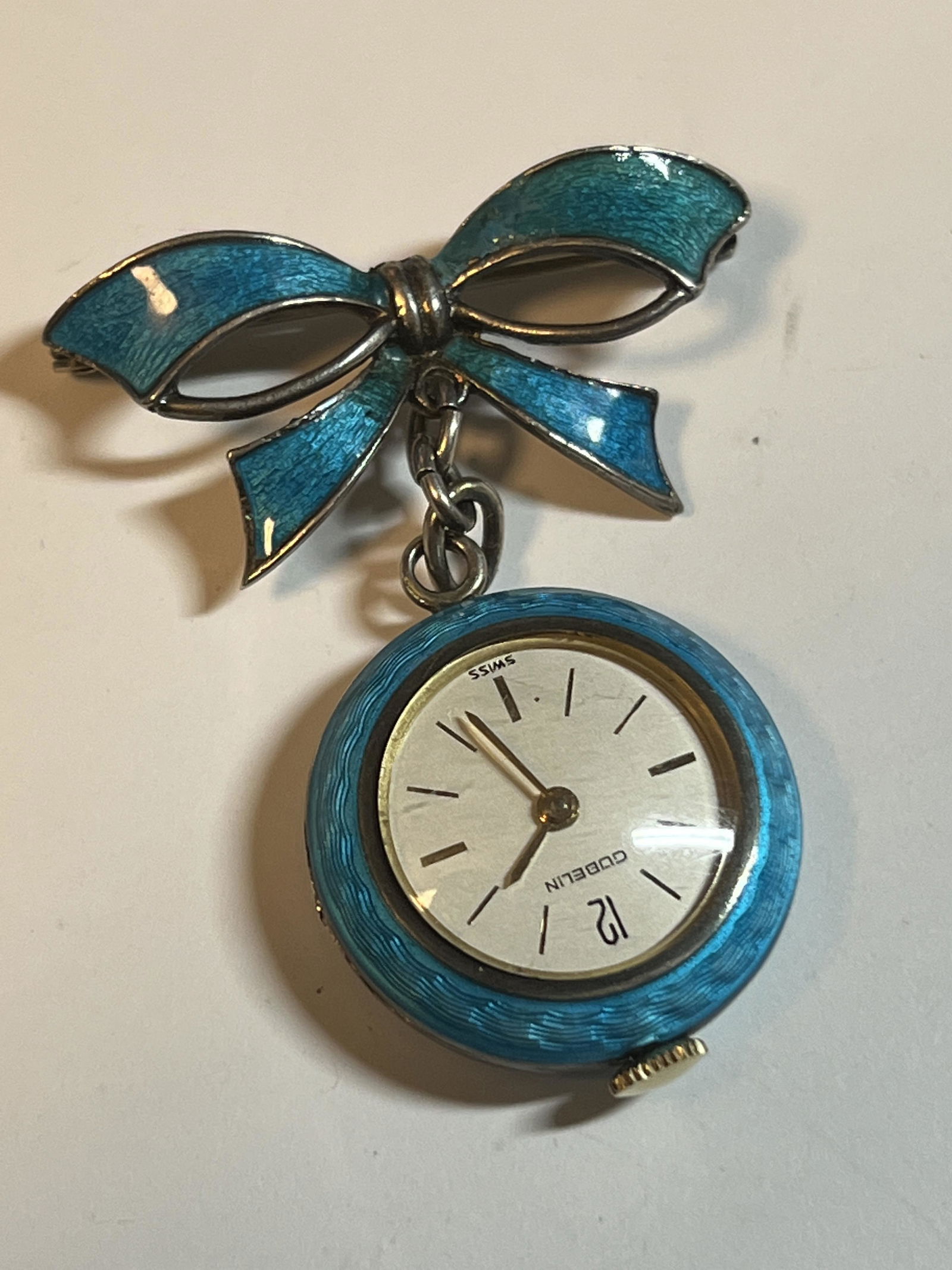 ANTIQUE SILVER ENAMEL GUBELIN WATCH BROOCH: ANTIQUE SILVER ENAMEL GUBELIN WATCH BROOCH. IN GOOD OVERALL SHAPE AND CONDITION. HAS A GREAT LOOK TO IT WITH AN EXCELLENT OVERALL EYE APPEAL. A GREAT FIND AND AN EXCELLENT ADDITION TO YOUR COLLECTION.