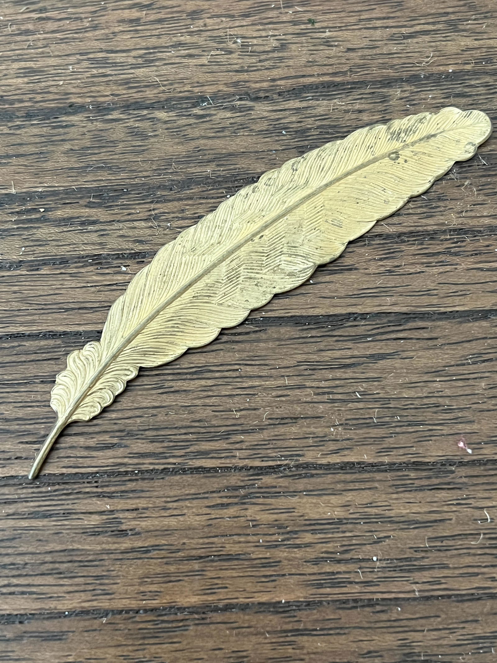 ANTIQUE NATIVE AMERICAN BRASS FEATHER: ANTIQUE NATIVE AMERICAN BRASS FEATHER. A GREAT FIND AND AN EXCELLENT ADDITION TO YOUR COLLECTION.