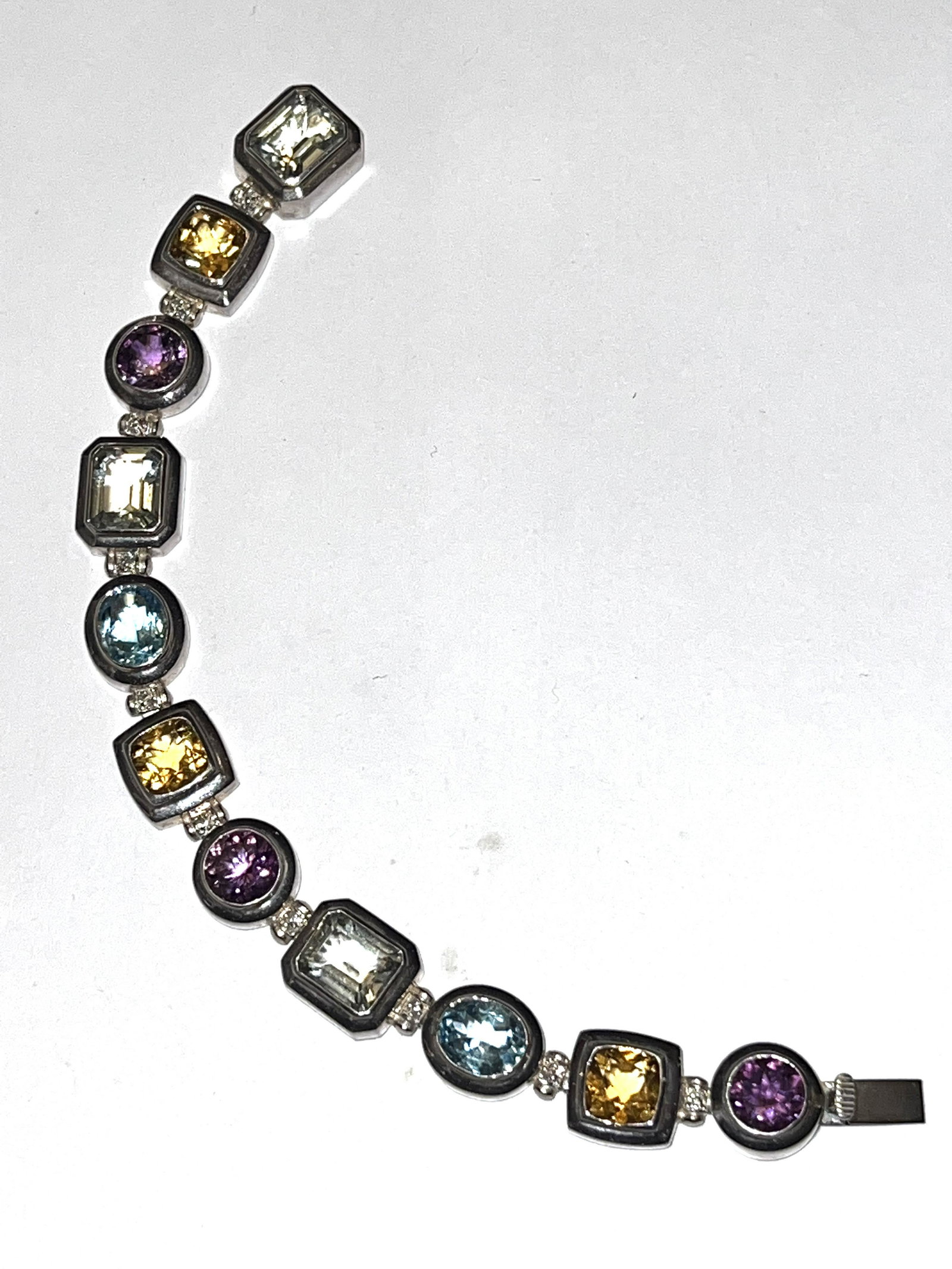 STERLING SILVER 22 TCW MULTI-GEMSTONE COCKTAIL BRACELET: STERLING SILVER 22 TCW MULTI-GEMSTONE COCKTAIL BRACELET. THIS IS A HEAVY BRACELET SET WITH 22 TCW OF MULTI-GEMSTONES. HAS A GREAT LOOK TO IT WITH AN EXCELLENT OVERALL EYE APPEAL. THIS IS TRULY A STUNN
