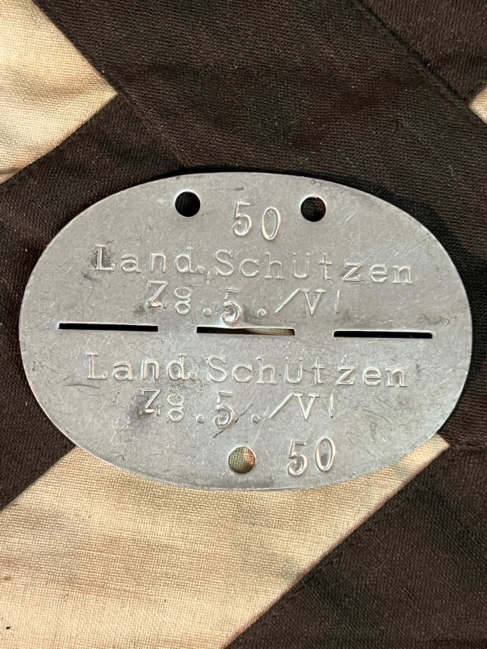 WW2 GERMAN NAZI OFFICER ID'D COMPLETE DOG TAG: WW2 GERMAN NAZI OFFICER ID'D COMPLETE DOG TAG. A RARE FIND. IT IS IN MINT OVERALL SHAPE AND CONDITION WITH A BEAUTIFUL OVERALL PATINA. HAS A GREAT LOOK TO IT WITH AN EXCELLENT OVERALL EYE APPEAL. A GR