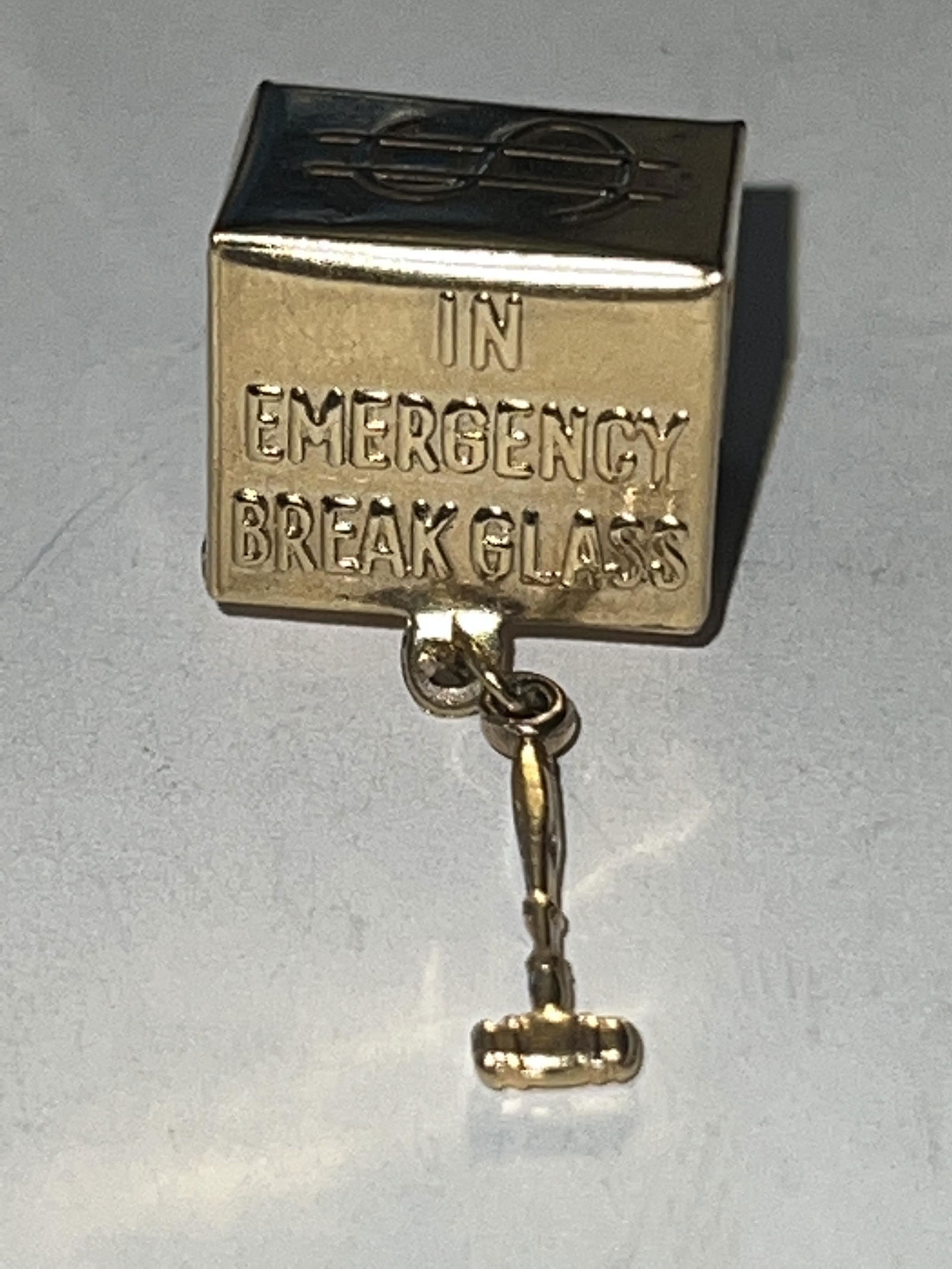 14K GOLD IN EMERGENCY BREAK GLASS PENDANT: 14K GOLD IN EMERGENCY BREAK GLASS PENDANT. IN MINT OVERALL SHAPE AND CONDITION. A GREAT FIND AND AN EXCELLENT ADDITION TO YOUR COLLECTION.