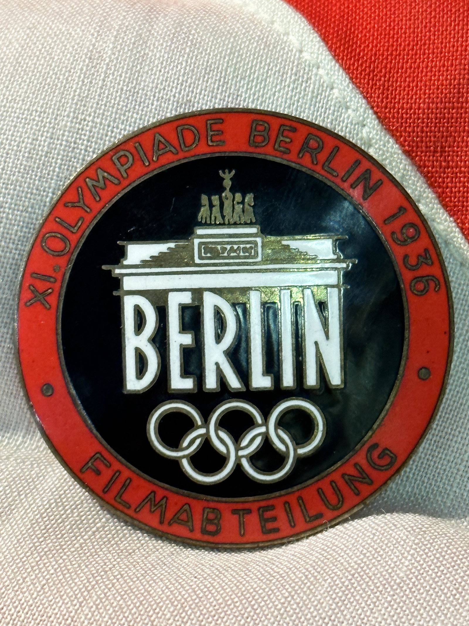 VET BRING BACK WW2 GERMAN OLYMPICS BERLIN ENAMELED BADGE: VET BRING BACK WW2 GERMAN OLYMPICS BERLIN ENAMELED BADGE - FILMABTEILUNG 1936. MAKER MARKED ROB. NEFF. BERLIN W51 ON THE BACK. PLEASE VIEW ALL DETAILED PICTURES. A WELL MADE ANTIQUE GERMAN ARTIFACT.