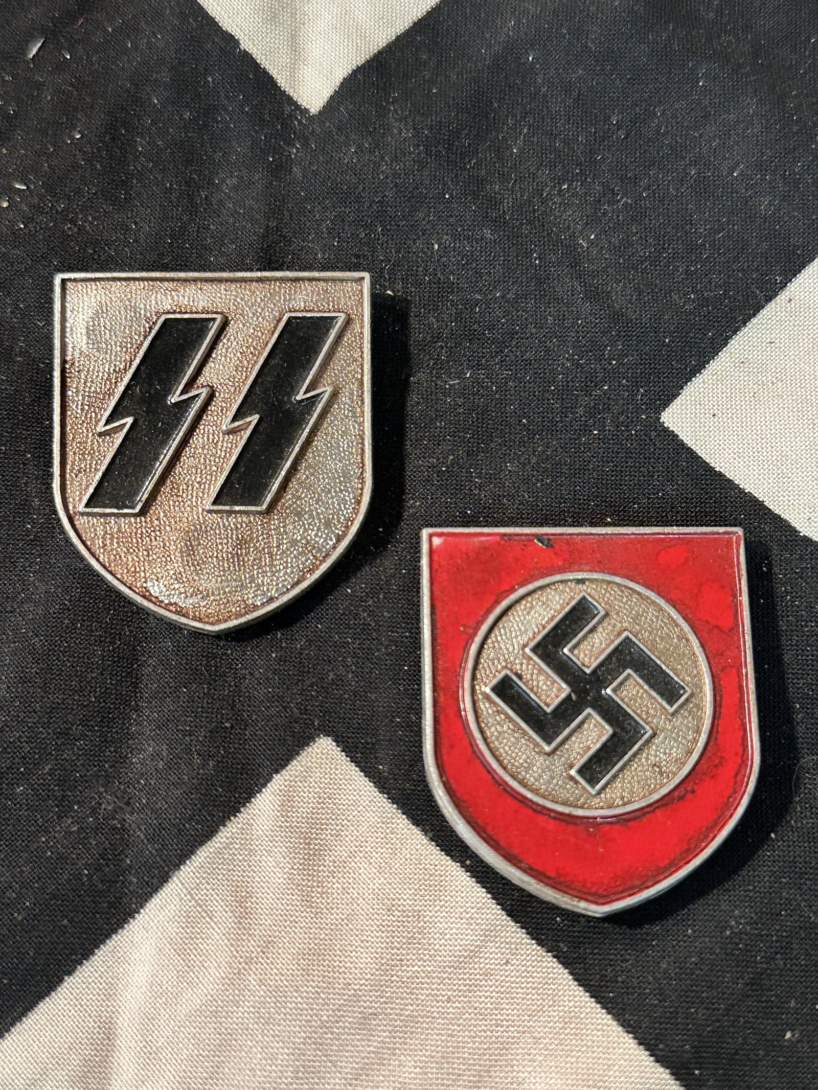 PAIR OF (2) WW2 GERMAN SS HELMET SHIELD INSIGNIAS: PAIR OF (2) WW2 GERMAN SS HELMET SHIELD INSIGNIAS. HAS THE MAKER MARKS ON THE BACK. IN MINT OVERALL SHAPE AND CONDITION. PLEASE VIEW ALL DETAILED PICTURES. A GREAT FIND AND AN EXCELLENT ADDITION TO YO