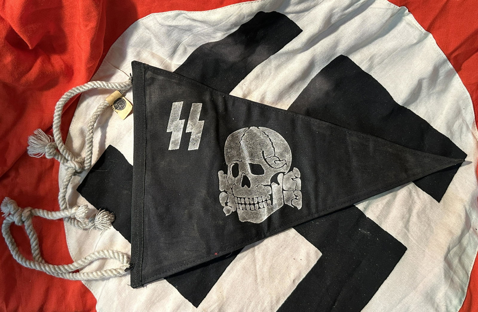 WW2 GERMAN TOTENKOPF SS SKULL PENNANT W/RZM TAG: WW2 GERMAN TOTENKOPF SS SKULL PENNANT W/RZM TAG. A RARE FIND. IT IS IN MINT OVERALL SHAPE AND CONDITION WITH A BEAUTIFUL PATINA THROUGHOUT. STILL HAS THE RZM TAG ATTACHED TO IT. PLEASE VIEW ALL DETAIL