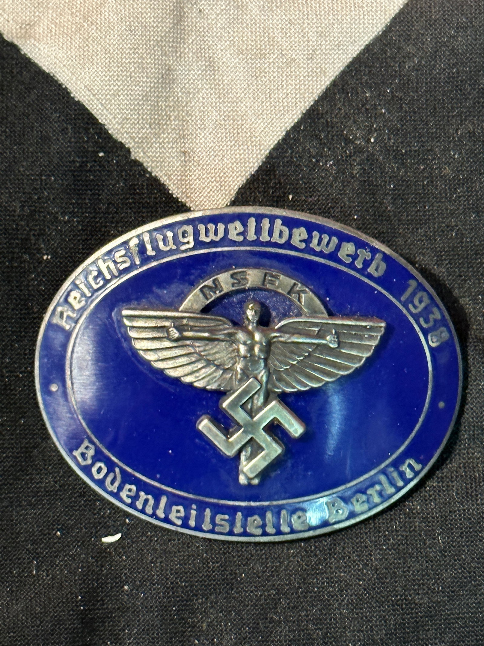 RARE WW2 GERMAN NSFK ENAMELED BADGE MAKER MARKED - ROB. NEFF BERLIN W57: RARE WW2 GERMAN NSFK ENAMELED BADGE MAKER MARKED - ROB. NEFF BERLIN W57. A RARE FIND. IT IS IN MINT OVERALL SHAPE AND CONDITION WITH A BEAUTIFUL OVERALL PATINA. SHOWS GOOD WEAR AND USE. PLEASE VIEW AL