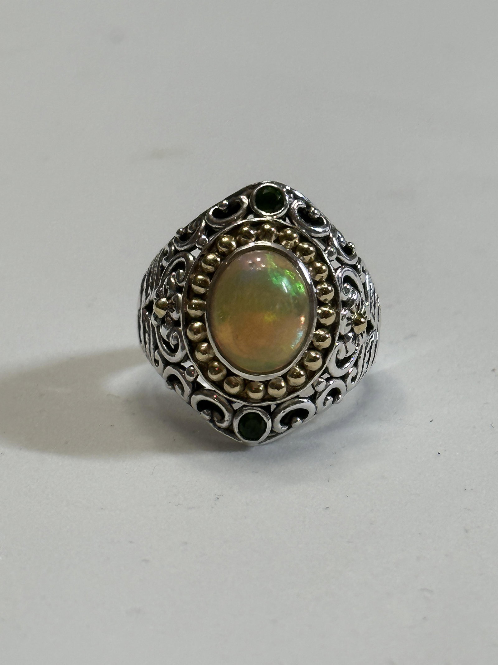 DESIGNER 18K AND STERLING OPAL COCKTAIL FULLY ENGRAVED RING SZ 7: DESIGNER 18K AND STERLING OPAL COCKTAIL FULLY ENGRAVED RING SZ 7. A RARE FIND. IT IS IN MINT OVERALL SHAPE AND CONDITION. A GREAT FIND AND AN EXCELLENT ADDITION TO YOUR COLLECTION.