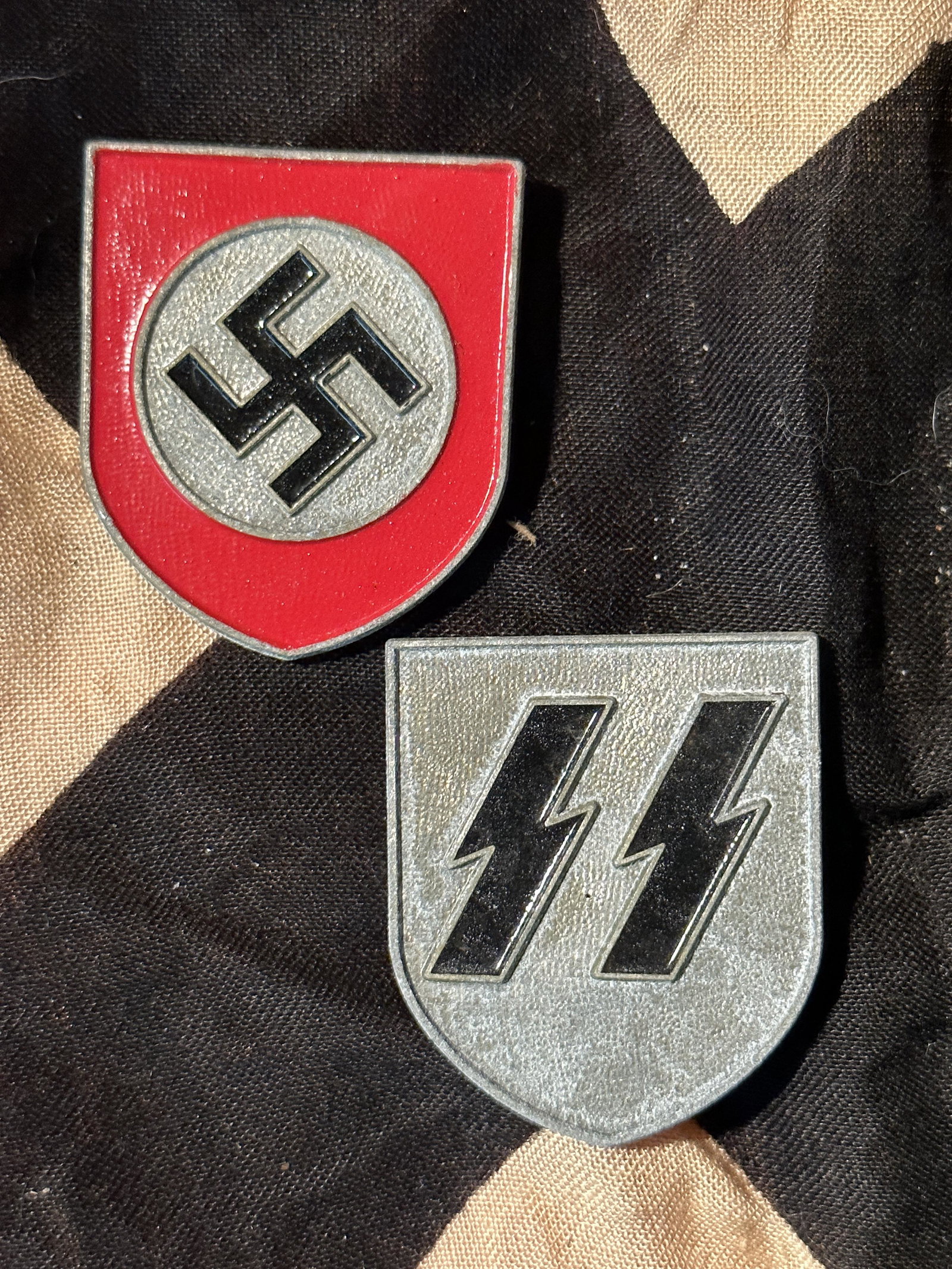 PAIR OF WW2 GERMAN SHIELDS FOR THE WAFFEN SS HELMET: PAIR OF WW2 GERMAN SHIELDS FOR THE WAFFEN SS HELMET - BOTH MARKED ON THE BACK RZM GES GESCH. IT IS IN MINT OVERALL SHAPE AND CONDITION WITH A BEAUTIFUL OVERALL PATINA. SHOWS GOOD WEAR AND HEAVY USE. P