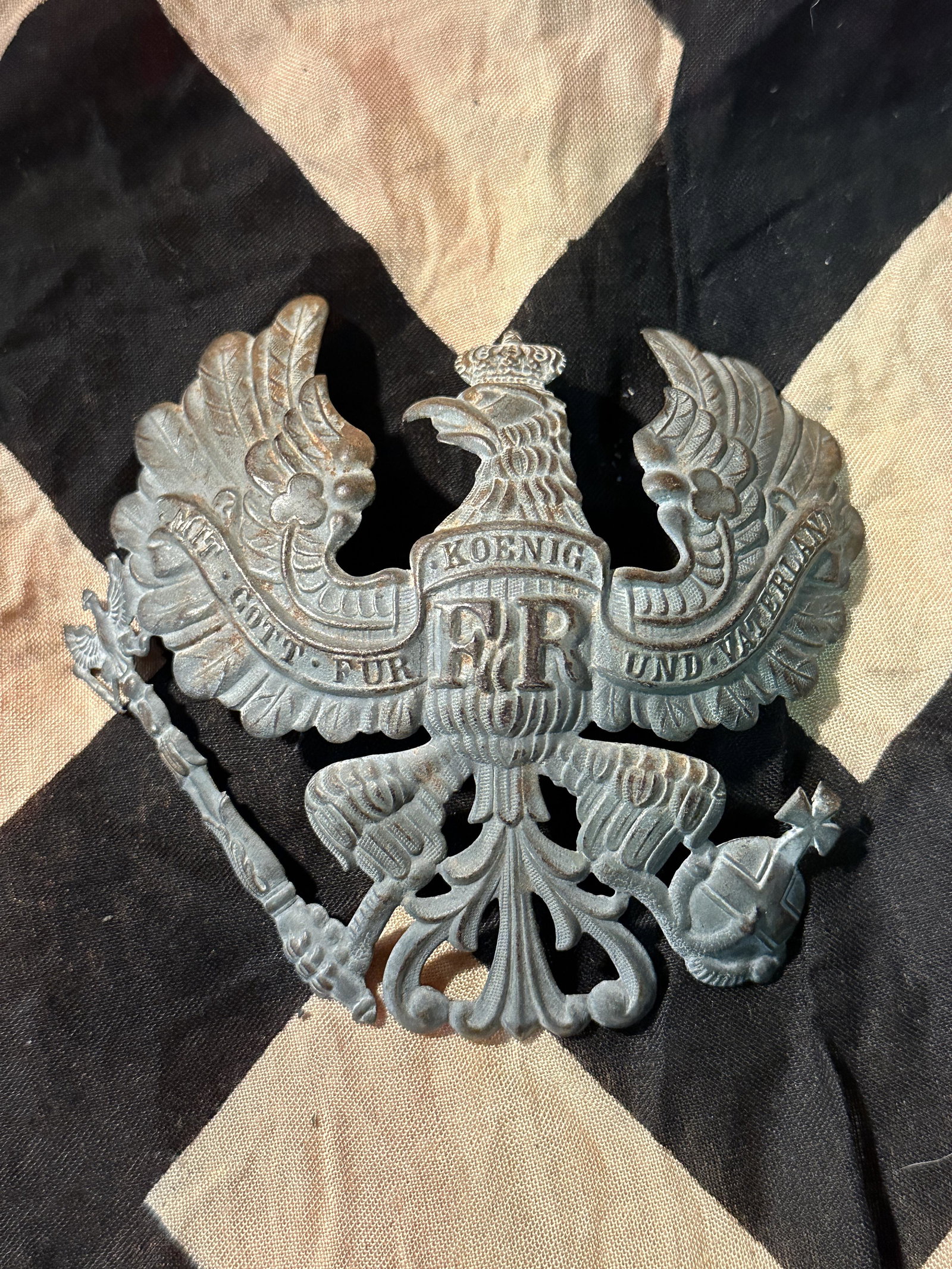WWI M1916 Prussian Pickelhaube Eagle Helmet Plate in Stamped Steel: WWI M1916 Prussian Pickelhaube Eagle Helmet Plate in Stamped Steel. IN MINT OVERALL SHAPE AND CONDITION WITH A BEAUTIFUL OVERALL PATINA. SHOWS GOOD WEAR AND USE. A WELL MADE ANTIQUE GERMAN ARTIFACT.