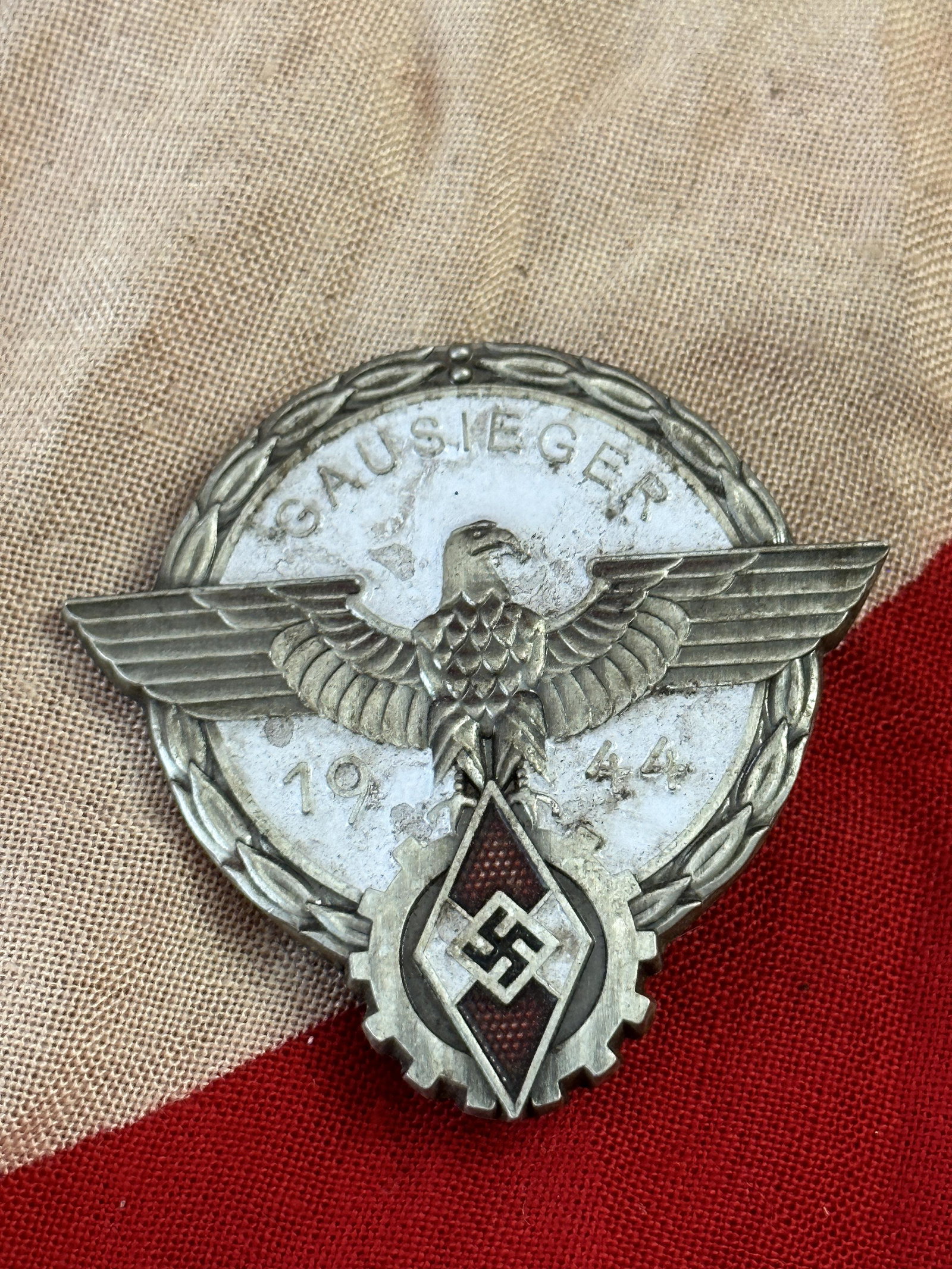 German WWII HJ 1944 Gausieger Victor's Badge by Gustav Brehmer: German WWII HJ 1944 Gausieger Victor's Badge by Gustav Brehmer. This is a very nice late war HJ Gau (State/District) Level 1944 national trade competition victors/winners (sieger) badge! The Reichsber