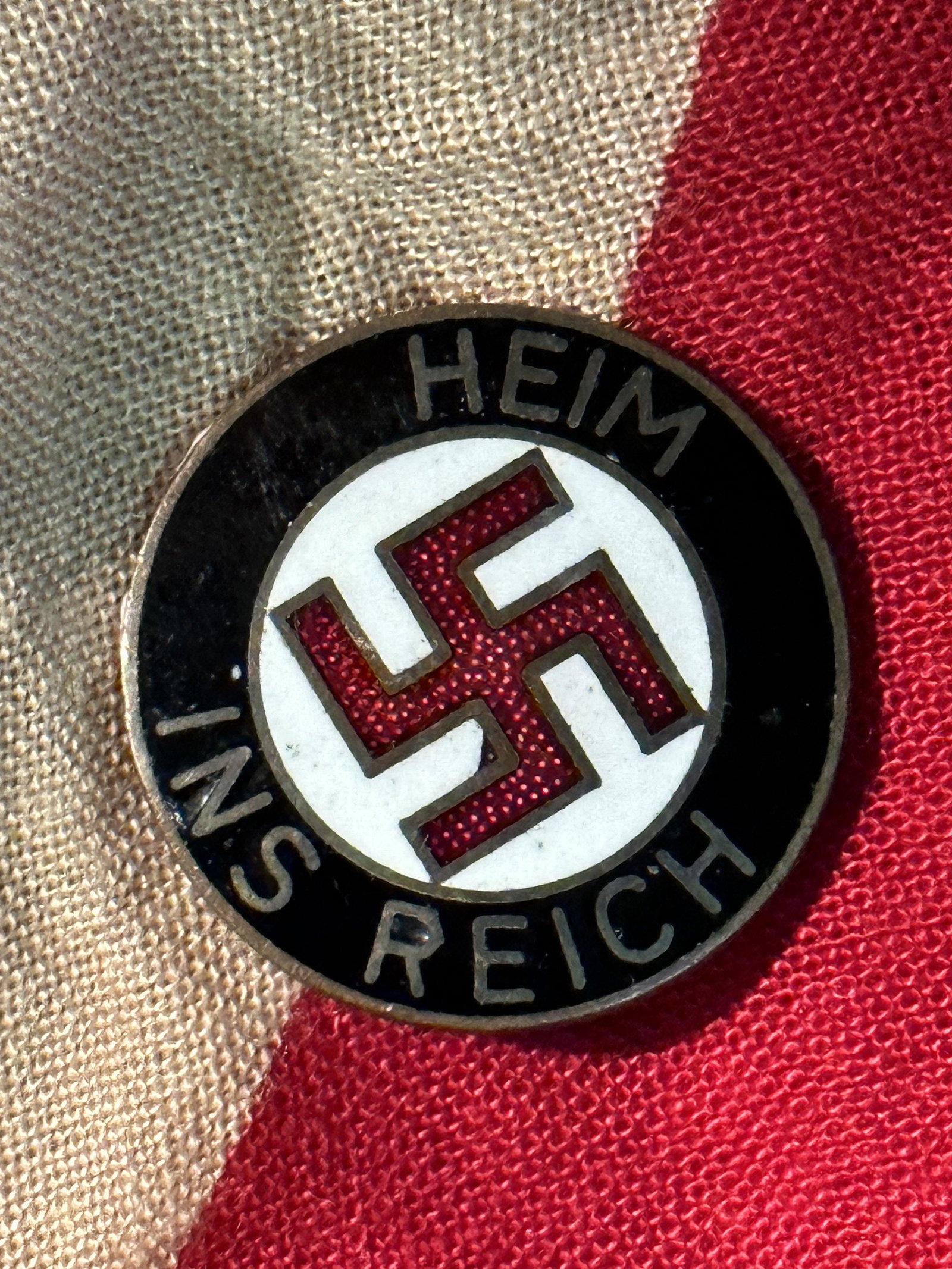 Original Enamel German NSDAP (NAZI PARTY) â€œHEIM INS REICHâ€ LAPEL PIN BY F.R.: Original Enamel German NSDAP (NAZI PARTY) â€œHEIM INS REICH” LAPEL PIN BY F.R. A RARE FIND. IT IS IN MINT OVERALL SHAPE AND CONDITION WITH A BEAUTIFUL OVERALL PATINA. SHOWS GOOD WEAR AND USE