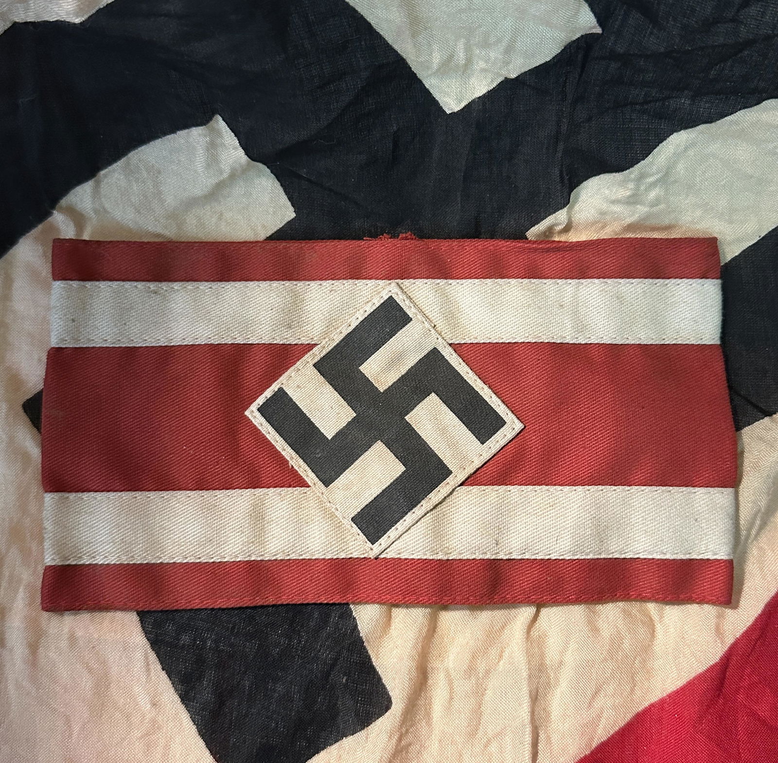 WWII German Bevo Hitler Youth Arm Band With RZM Paper Tag: WWII German Bevo Hitler Youth Arm Band With RZM Paper Tag. Nice example showing wear and tear with a beautiful overall patina. Expected wear and use. Please view all detailed pictures. A well made ant