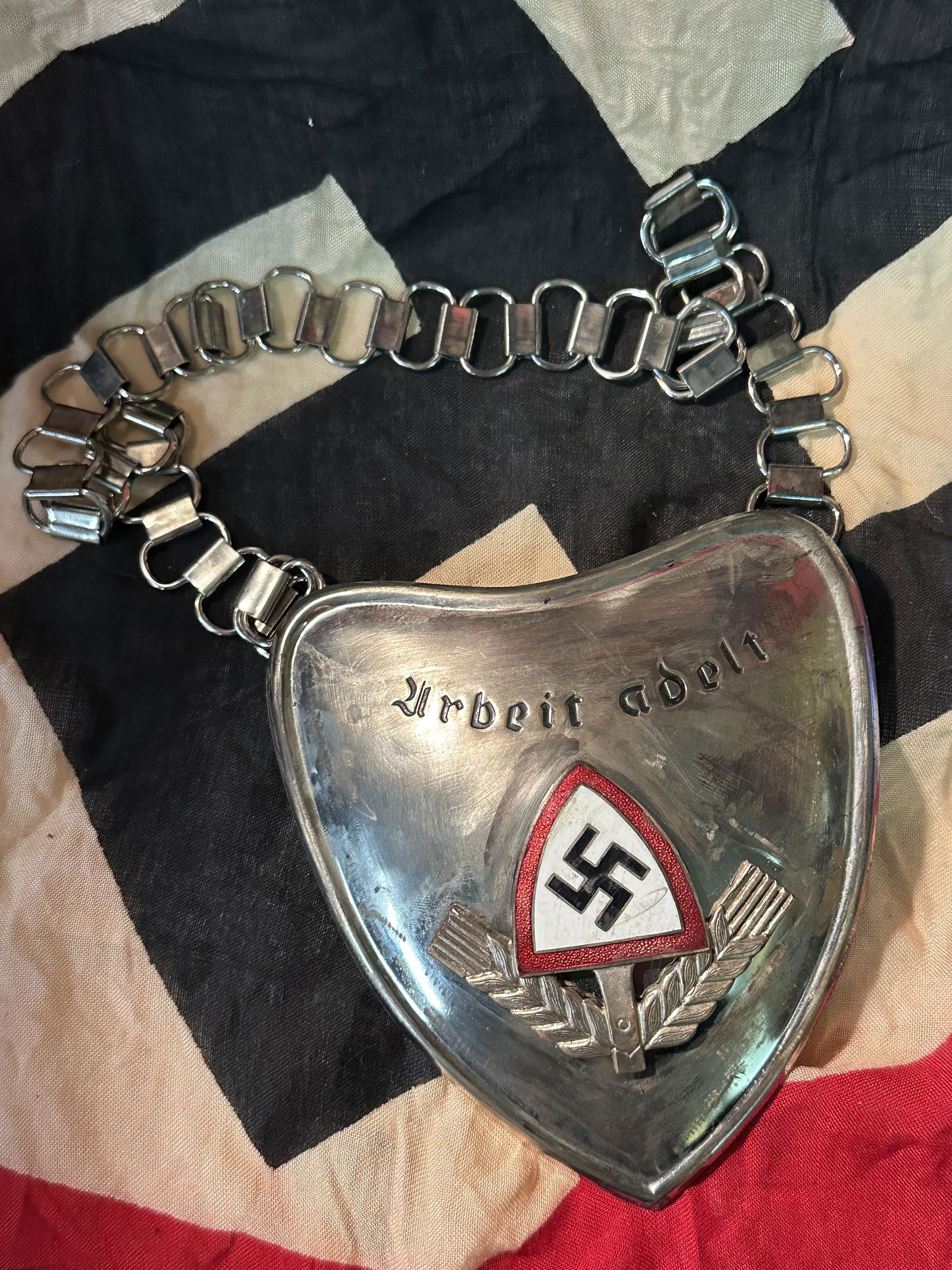 WWII GERMAN RAD OFFICERS ARBEIT ADELT GORGET: WWII GERMAN RAD OFFICERS ARBEIT ADELT GORGET. WWII German RAD arbeit adelt officer's gorget with chain. Obverse: RAD enameled insignia with "arbeit adelt" to top. Reverse: non fluorescing felt backing