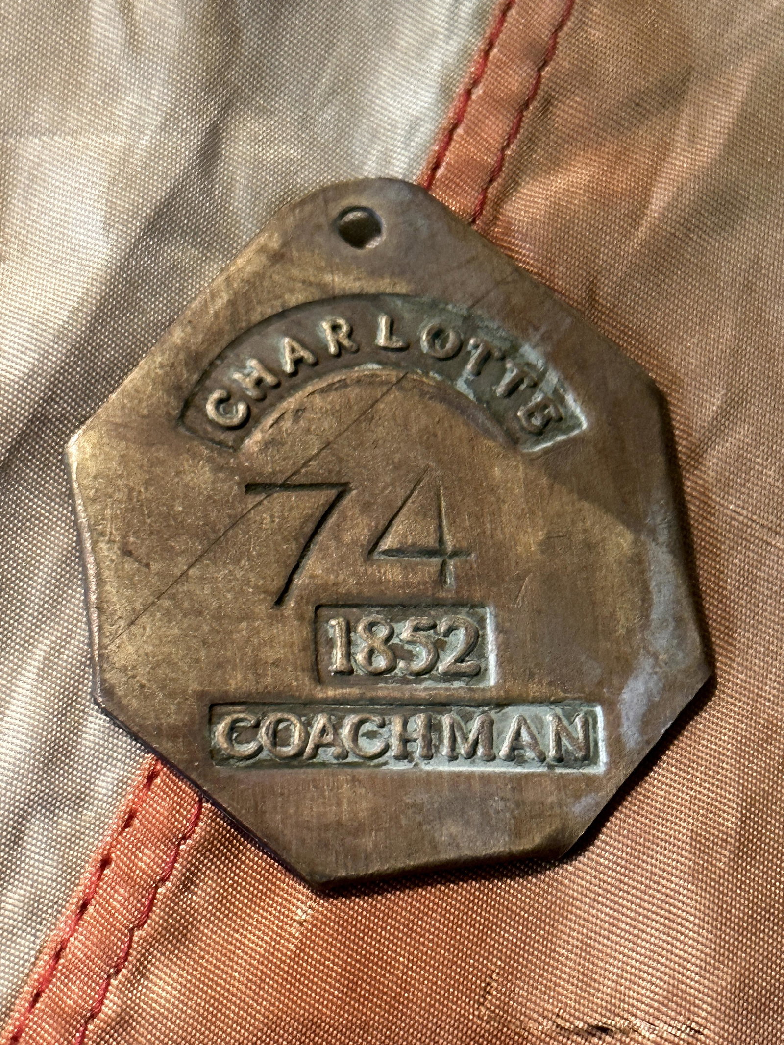 DATED 1852 COACHMAN CHARLOTTE #74 SERVANT SLAVE TAG: DATED 1852 COACHMAN CHARLOTTE #74 SERVANT SLAVE TAG. A RARE FIND. IT IS IN MINT OVERALL SHAPE AND CONDITION WITH A BEAUTIFUL OVERALL PATINA. SHOWS GOOD WEAR AND USE. PLEASE VIEW ALL DETAILED PICTURES.
