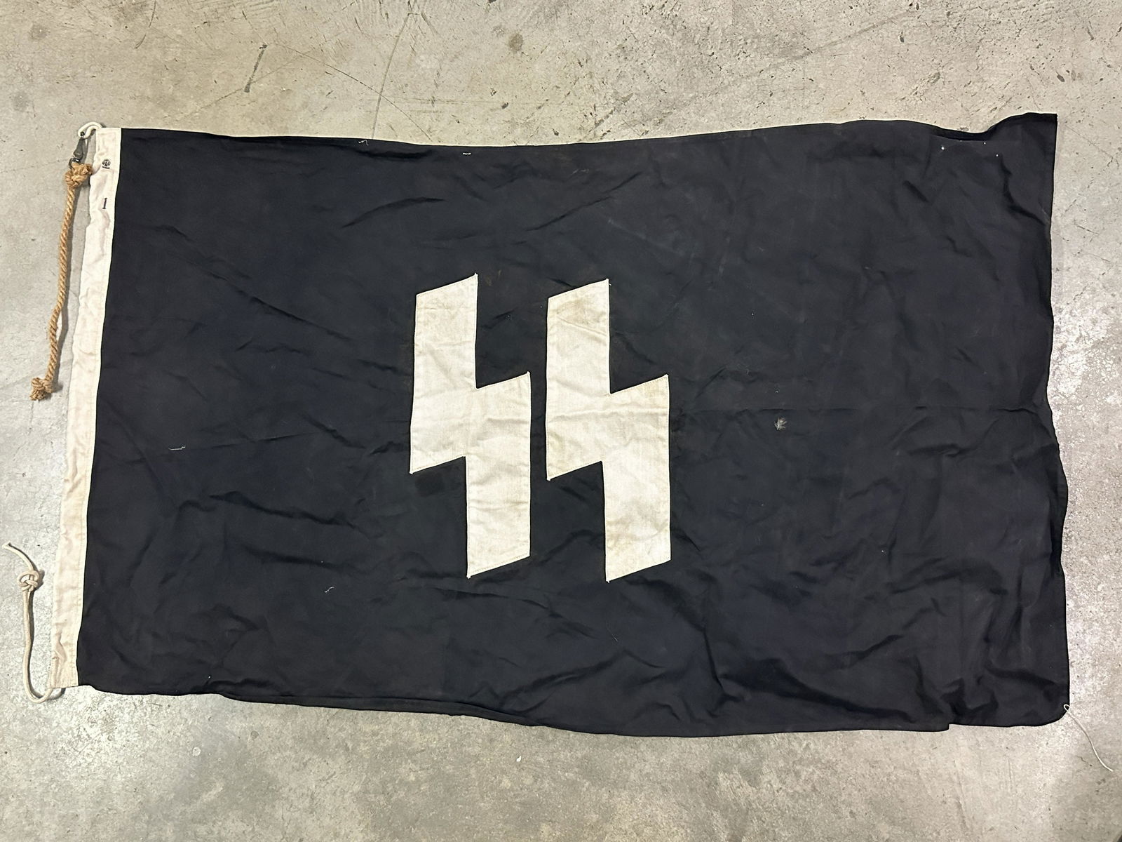 RARE WW2 GERMAN WAFFEN-SS FLAG BY RZM - MAKER MARKED: RARE WW2 GERMAN WAFFEN-SS FLAG BY RZM - MAKER MARKED. A VERY RARE FIND. IT IS IN MINT OVERALL SHAPE AND CONDITION WITH A BEAUTIFUL OVERALL PATINA. SHOWS GOOD WEAR AND USE. PLEASE VIEW ALL DETAILED PIC