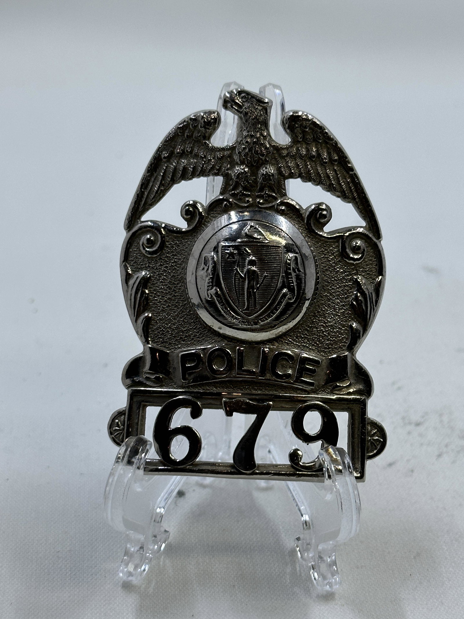 VINTAGE POLICE BADGE #679: VINTAGE POLICE BADGE #679. A RARE FIND. IT IS IN MINT OVERALL SHAPE AND CONDITION. A GREAT FIND AND AN EXCELLENT ADDITION TO YOUR COLLECTION.