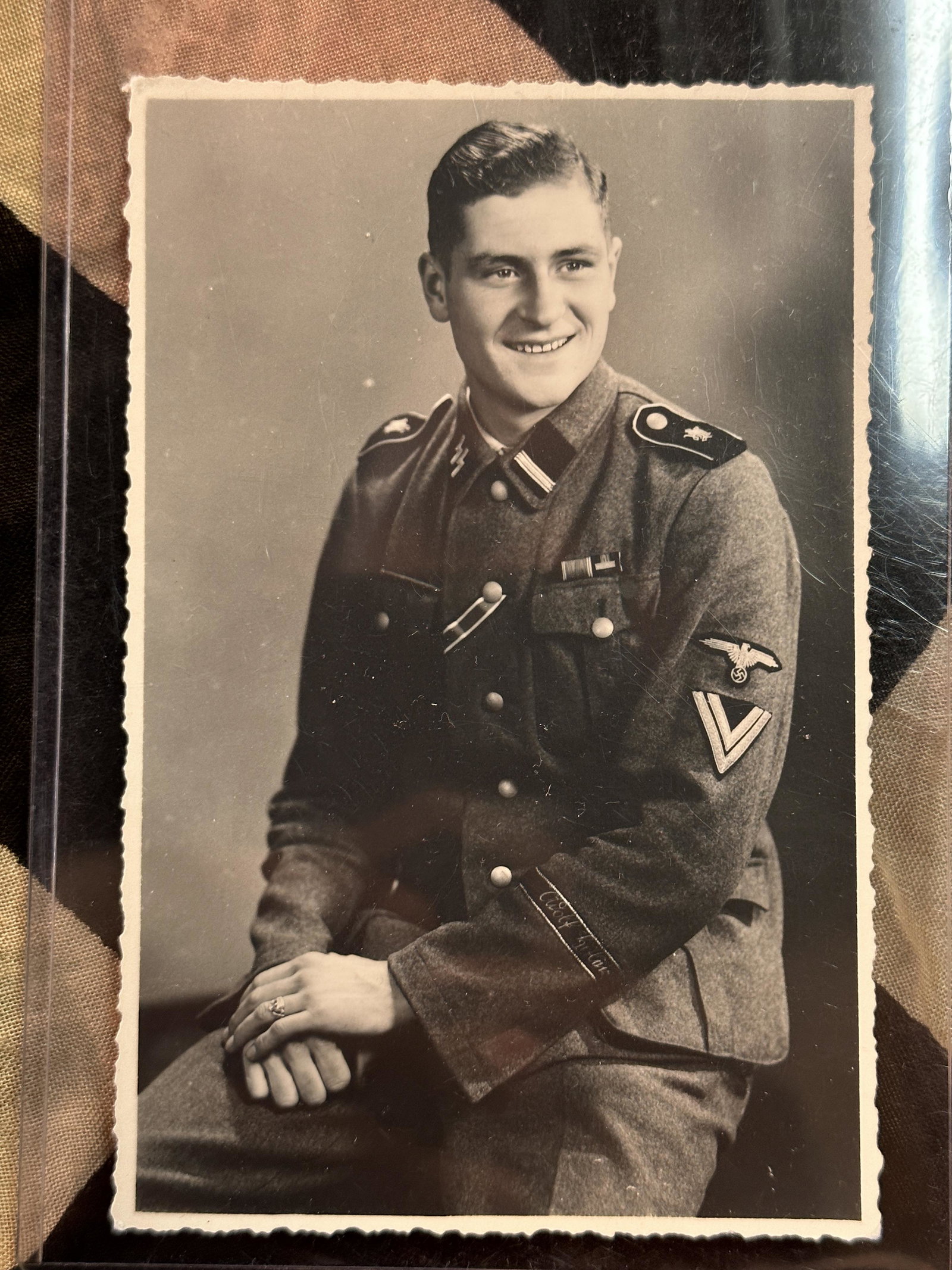 RARE WW2 GERMAN WAFFEN SS SOLDIER PHOTOGRAPH IN FULL UNIFORM: RARE WW2 GERMAN WAFFEN SS SOLDIER PHOTOGRAPH IN FULL UNIFORM. A RARE PHOTOGRAPH IN WHICH THE SOLDIER IS WEARING A WAFFEN SS TUNIC WHICH IS WORN WITH THE ADOLF HITLER CUFF TITLE, SS COLLAR TABS, ETC. P