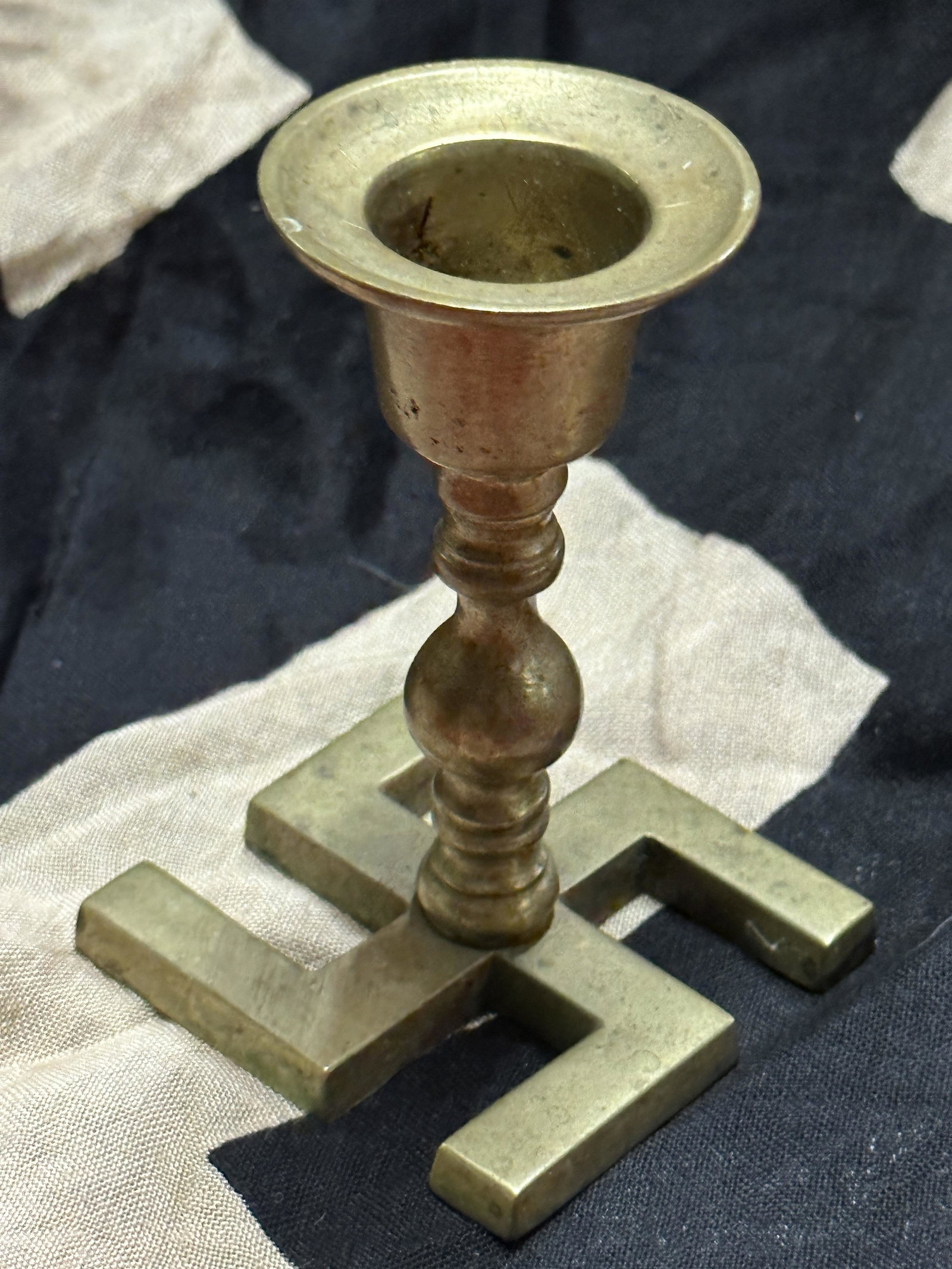 RARE WW2 GERMAN SWASTIKA CANDLE STICK HOLDER: RARE WW2 GERMAN SWASTIKA CANDLE STICK HOLDER. A VERY RARE FIND. IT IS IN MINT OVERALL SHAPE AND CONDITION WITH A BEAUTIFUL OVERALL PATINA. SHOWS GOOD WEAR AND USE. PLEASE VIEW ALL DETAILED PICTURES. A