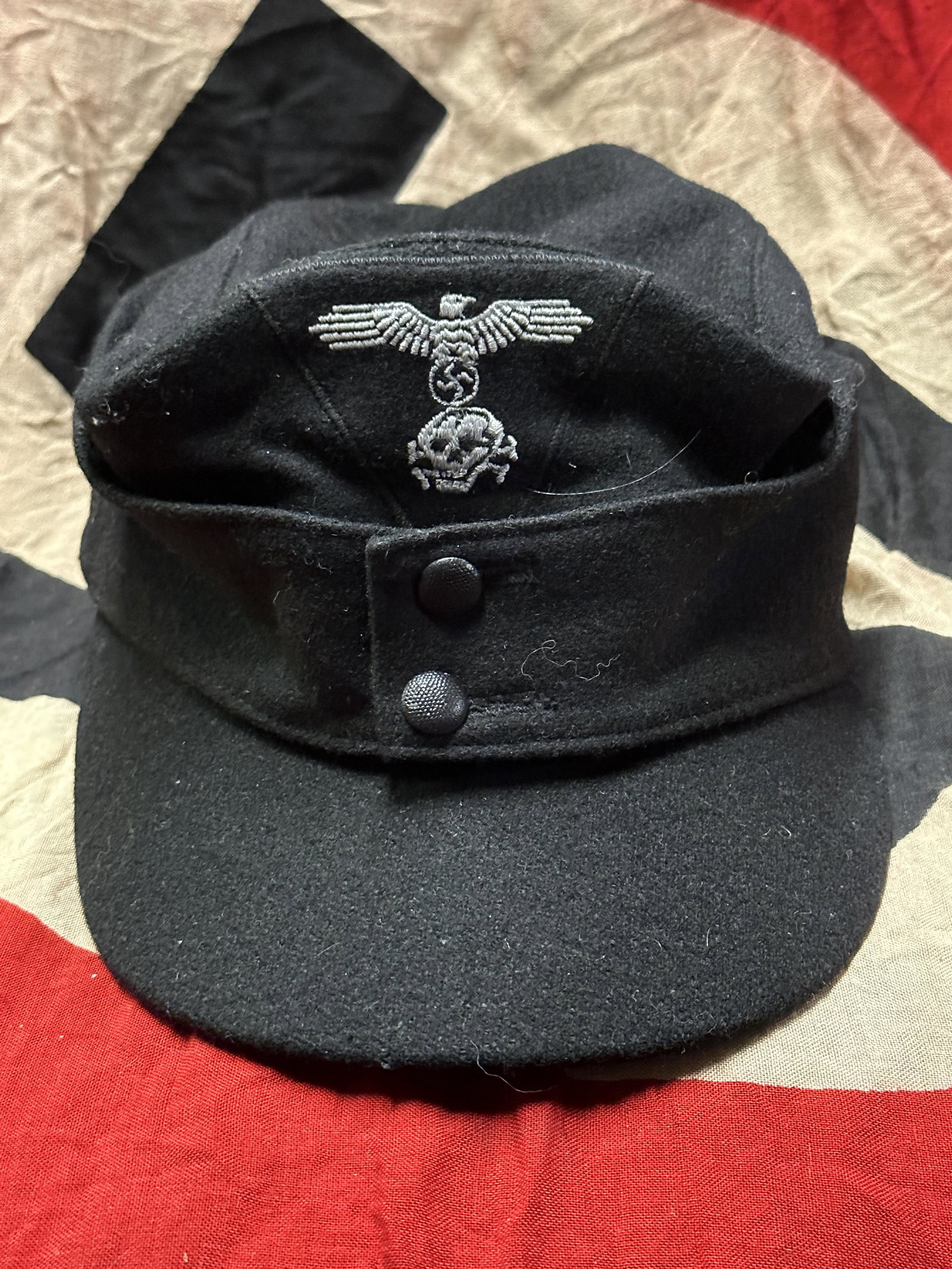 RARE WW2 GERMAN WAFFEN-SS PANZER ENLISTED MAN'S M43 CAP: RARE WW2 GERMAN WAFFEN-SS PANZER ENLISTED MAN'S M43 CAP. A rare article of Third Reich headgear, an M43-style enlisted man's cap in black, as worn by Panzer crews, constructed of a black wool and rayo