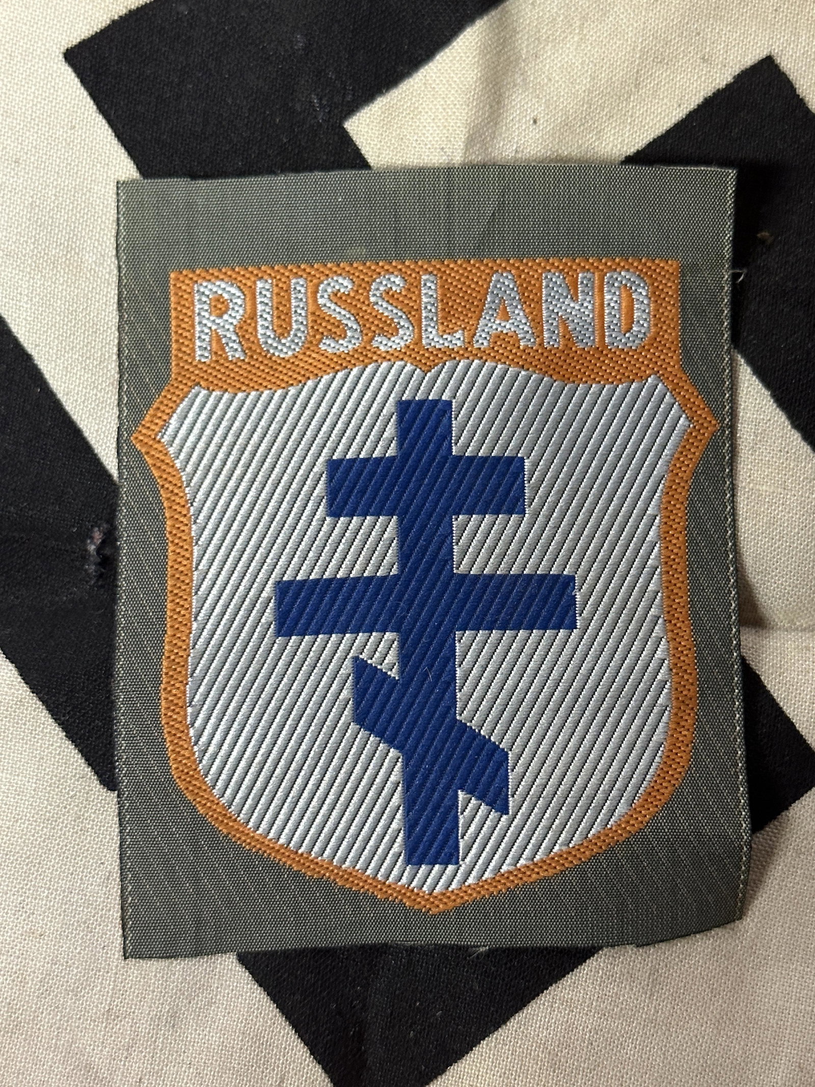 WW2 GERMAN RUSSIAN ALLIED TROOPS SLEEVE CLOTH SHIELD BADGE: WW2 GERMAN RUSSIAN ALLIED TROOPS SLEEVE CLOTH SHIELD BADGE. IT IS IN MINT OVERALL SHAPE AND CONDITION WITH A BEAUTIFUL OVERALL PATINA. SHOWS GOOD WEAR AND USE. PLEASE VIEW ALL DETAILED PICTURES. A WEL