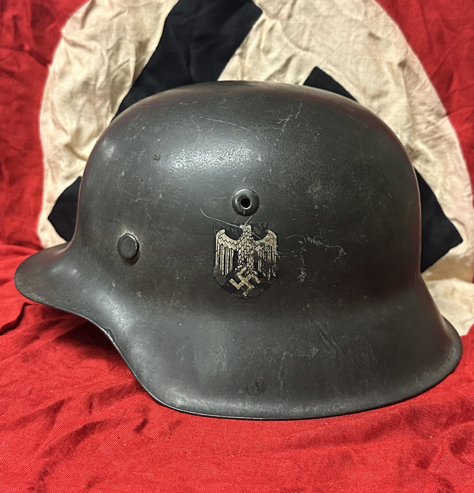 WW2 German Service Used Heer M40 Single Decal Helmet: WW2 German Service Used Heer M40 Single Decal Helmet. This is an excellent example of a Heer M40 NS64, with rough texture schiefergrau finish and Heer adler. Shows good wear and use with a beautiful p