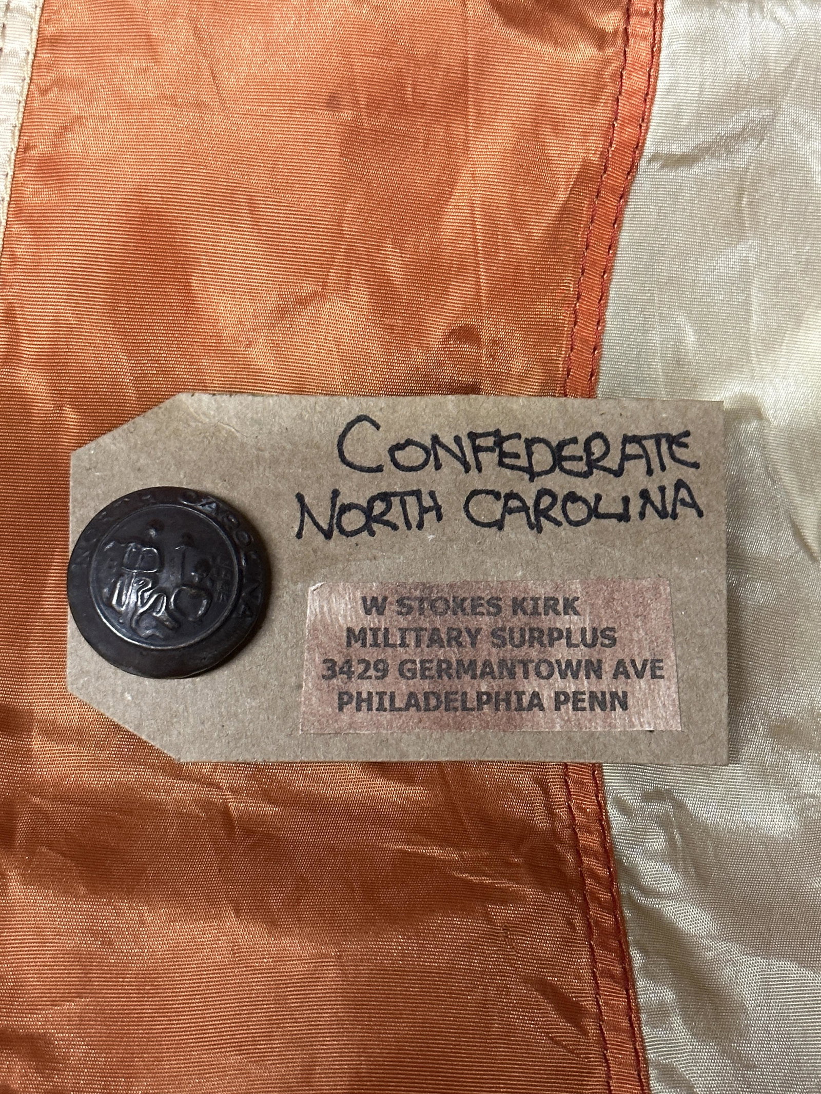 RARE CIVIL WAR CONFEDERATE NORTH CAROLINA BUTTON BY W. STOKES KIRK: RARE CIVIL WAR CONFEDERATE NORTH CAROLINA BUTTON BY W. STOKES KIRK. COMES WITH THE ORIGINAL MAKER MARK TAG. HAS A BEAUTIFUL PATINA THROUGHOUT. A GREAT FIND AND AN EXCELLENT ADDITION TO YOUR COLLECTION